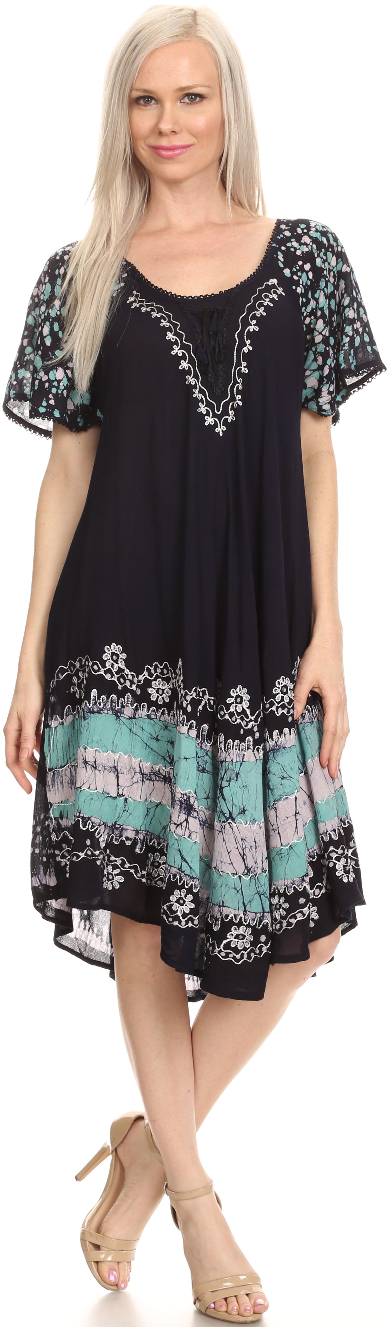 Woman wearing a black dress with colorful patterns and embroidery.