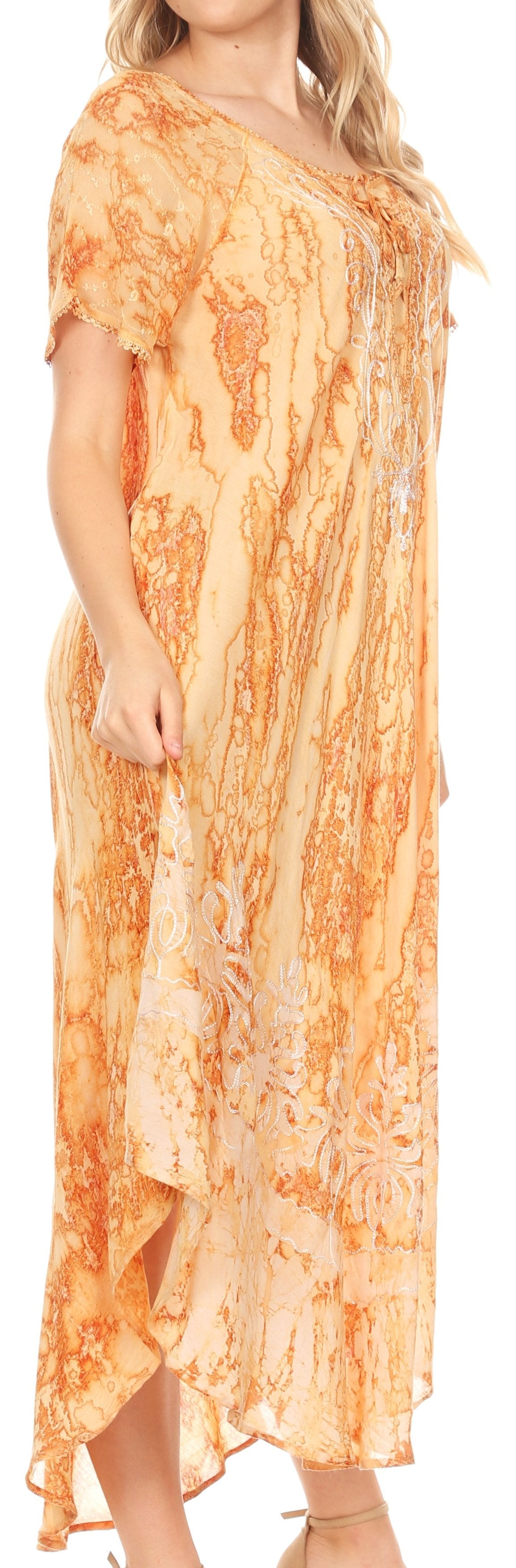 Woman wearing a long, patterned dress with a neutral background