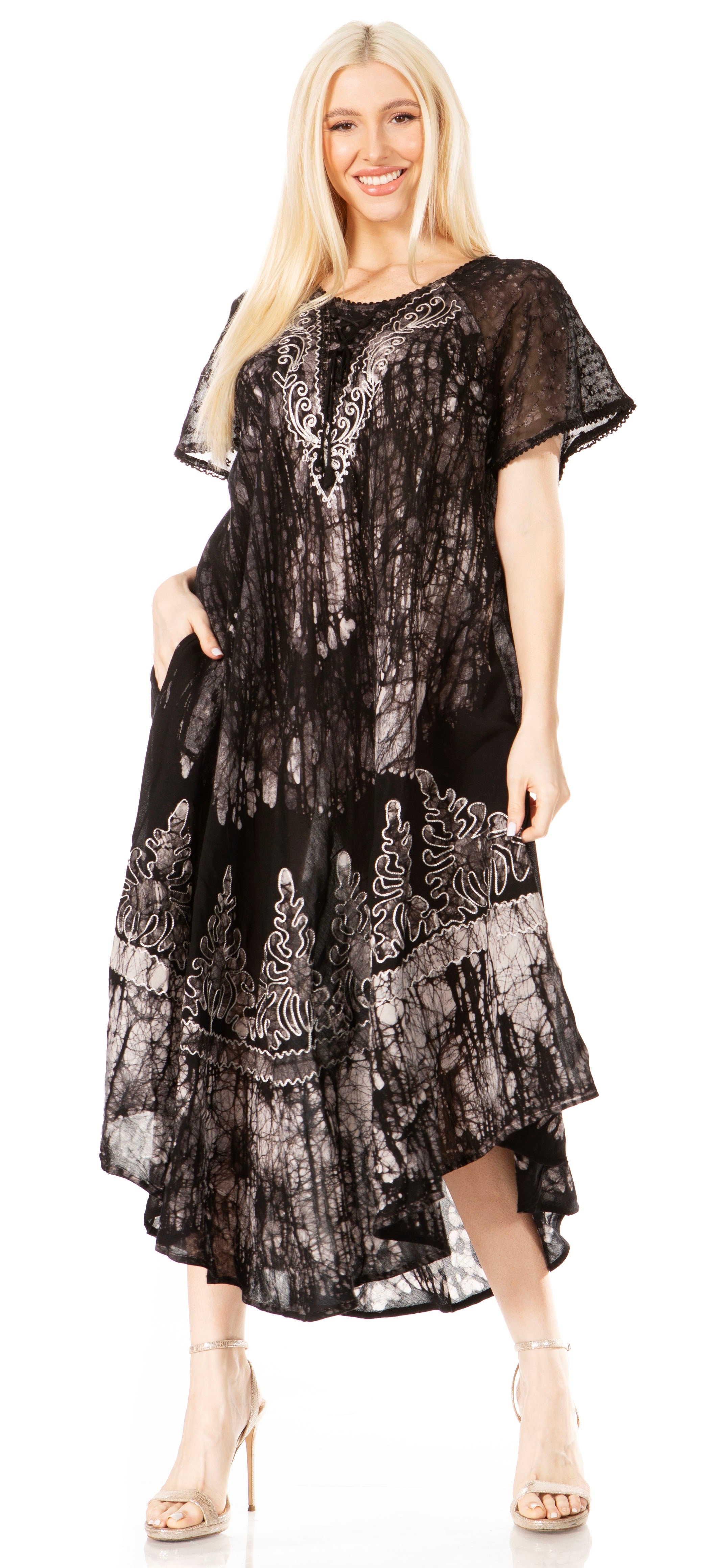 Woman wearing a black and silver patterned dress on a white background