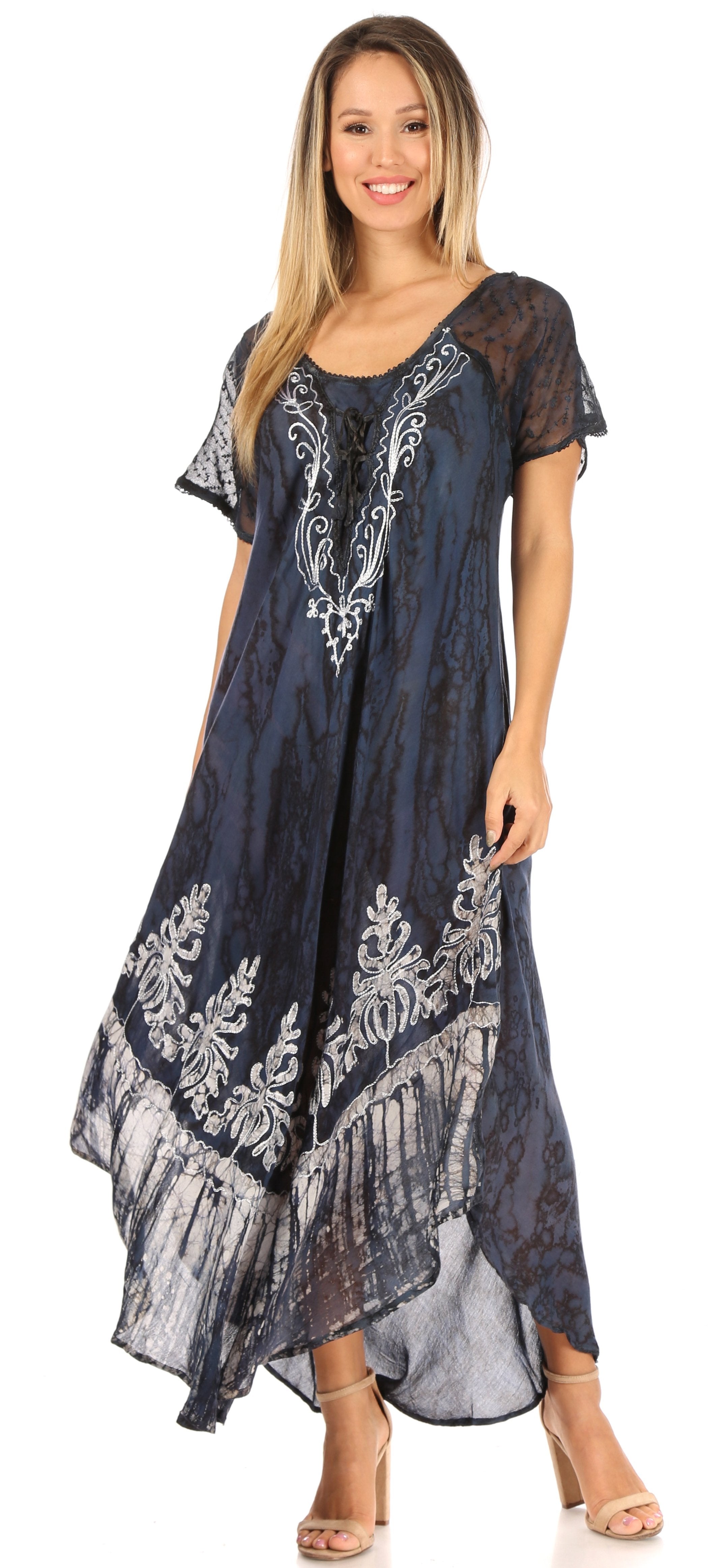 Woman wearing a navy blue dress with white floral patterns on a white background