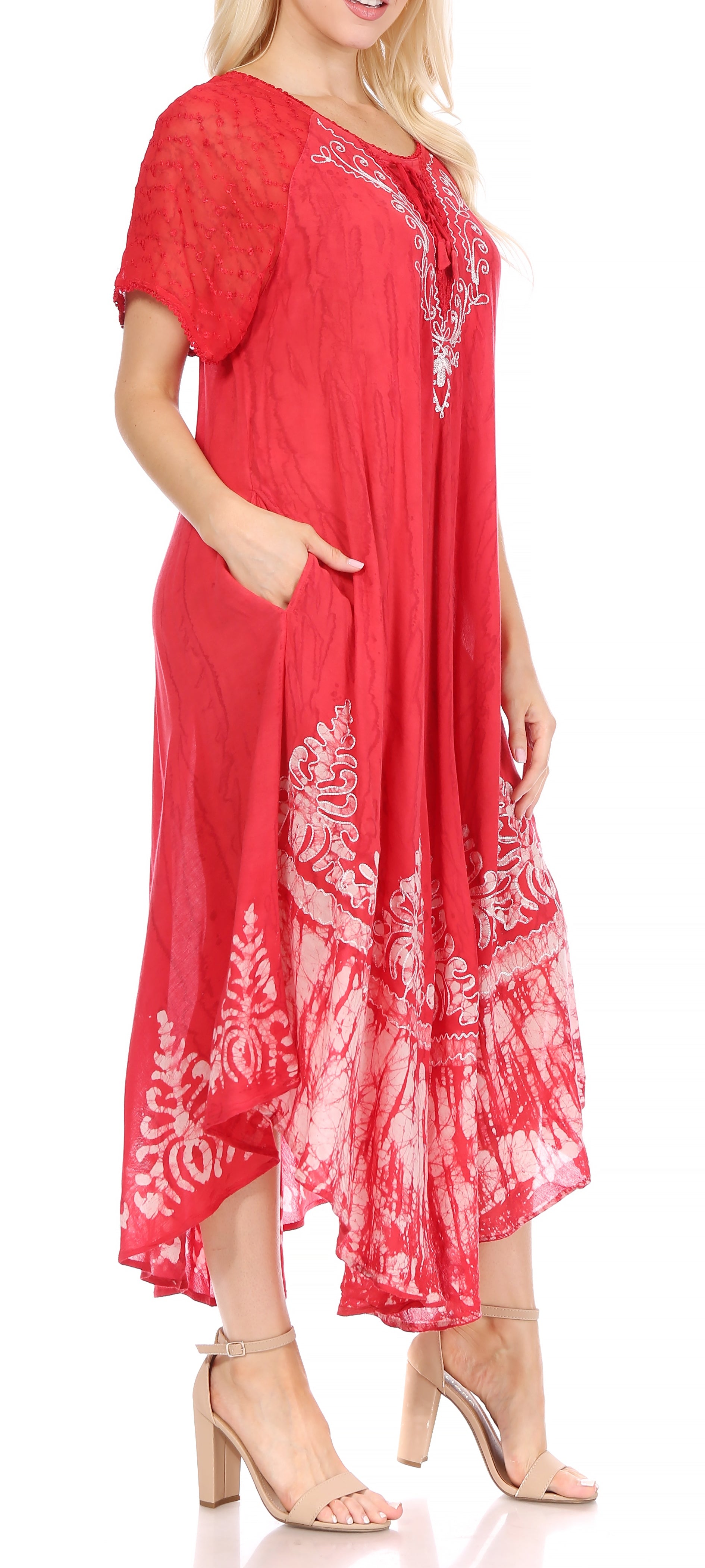 Red dress with white patterns worn by a model on a white background