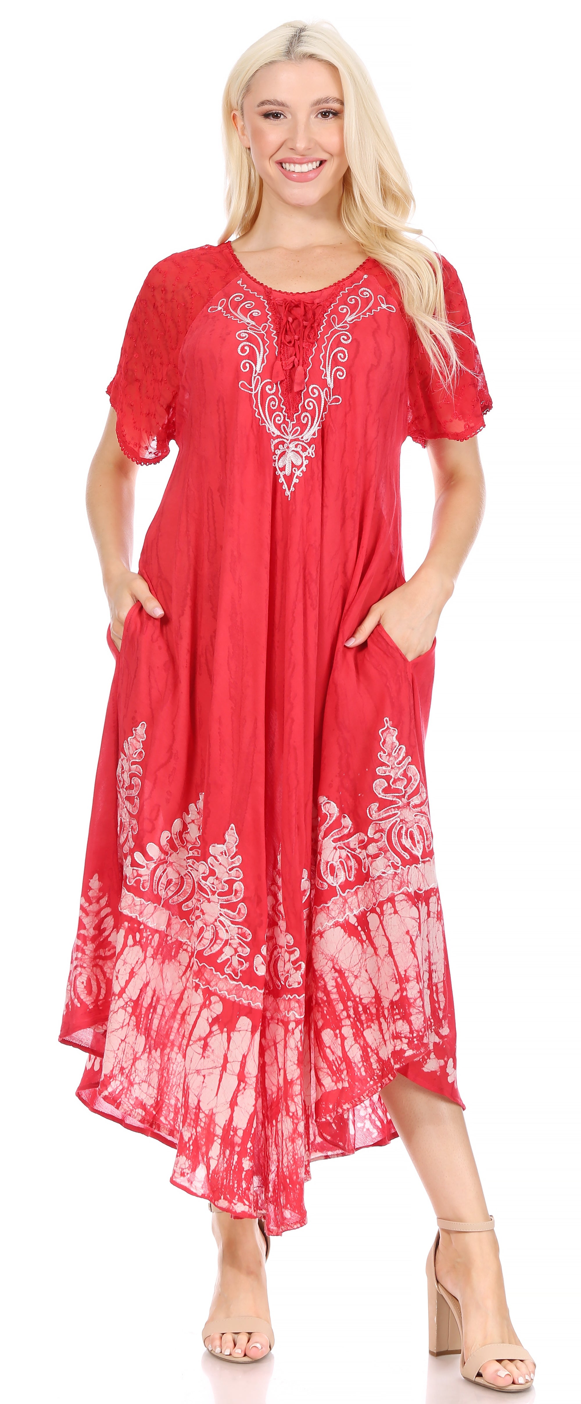 Woman wearing a red dress with white patterns on a white background