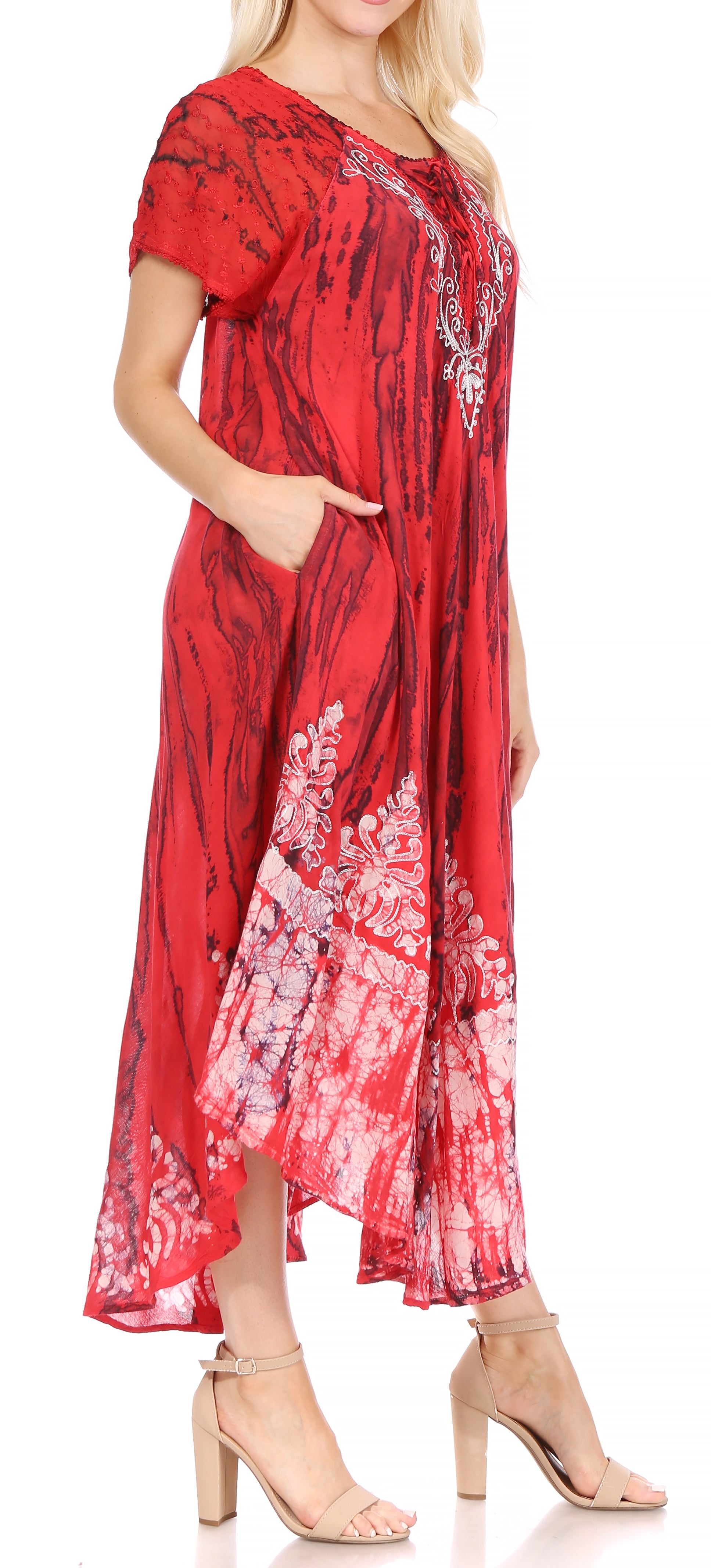 Red patterned dress worn by a model on a white background