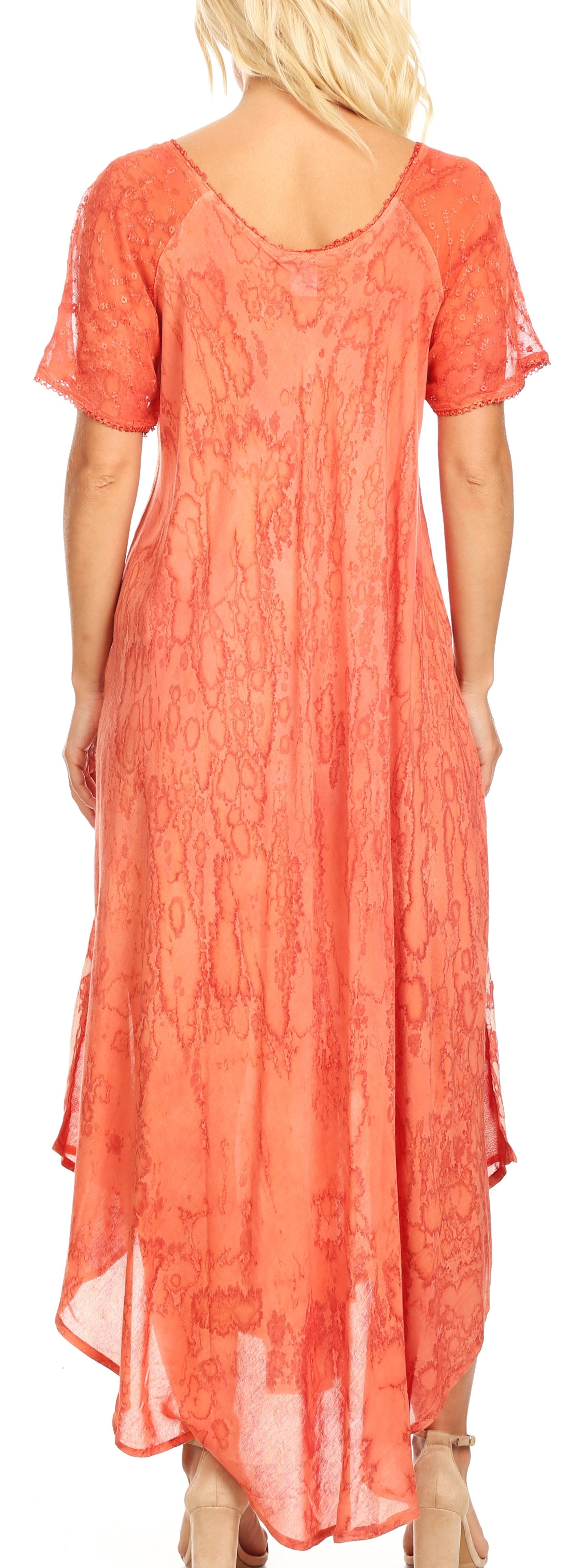 Woman wearing a coral lace dress with a plain background