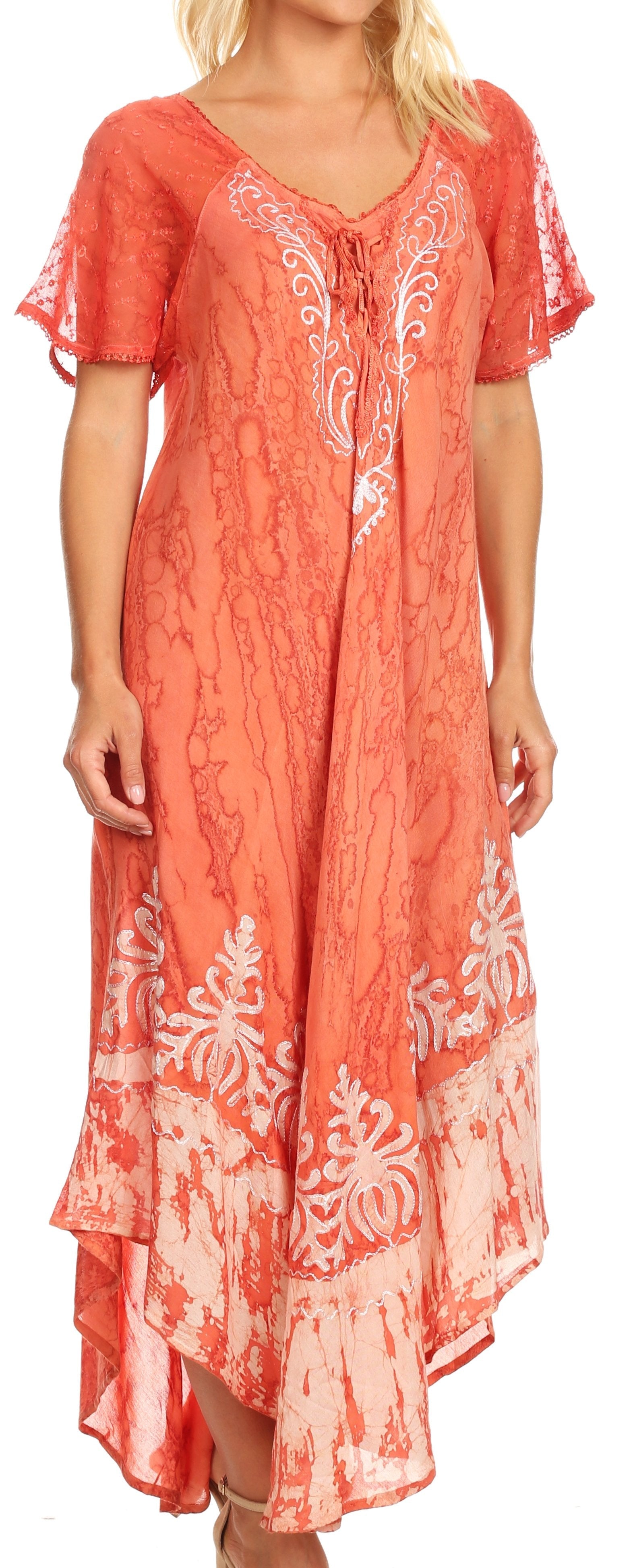 Woman wearing a coral dress with white floral patterns