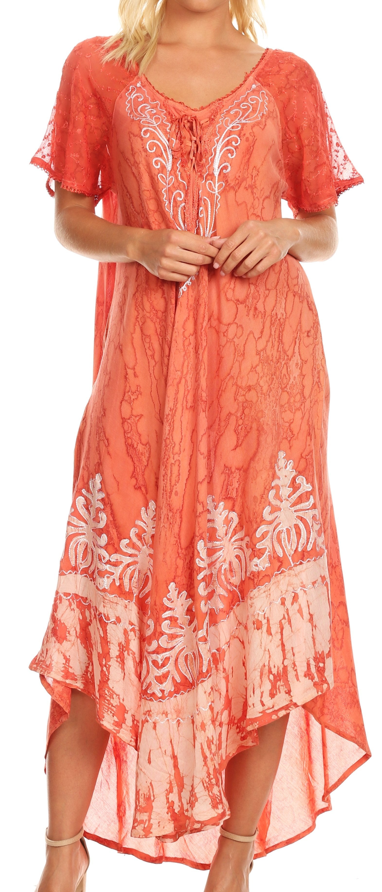 Coral dress with white floral patterns worn by a model