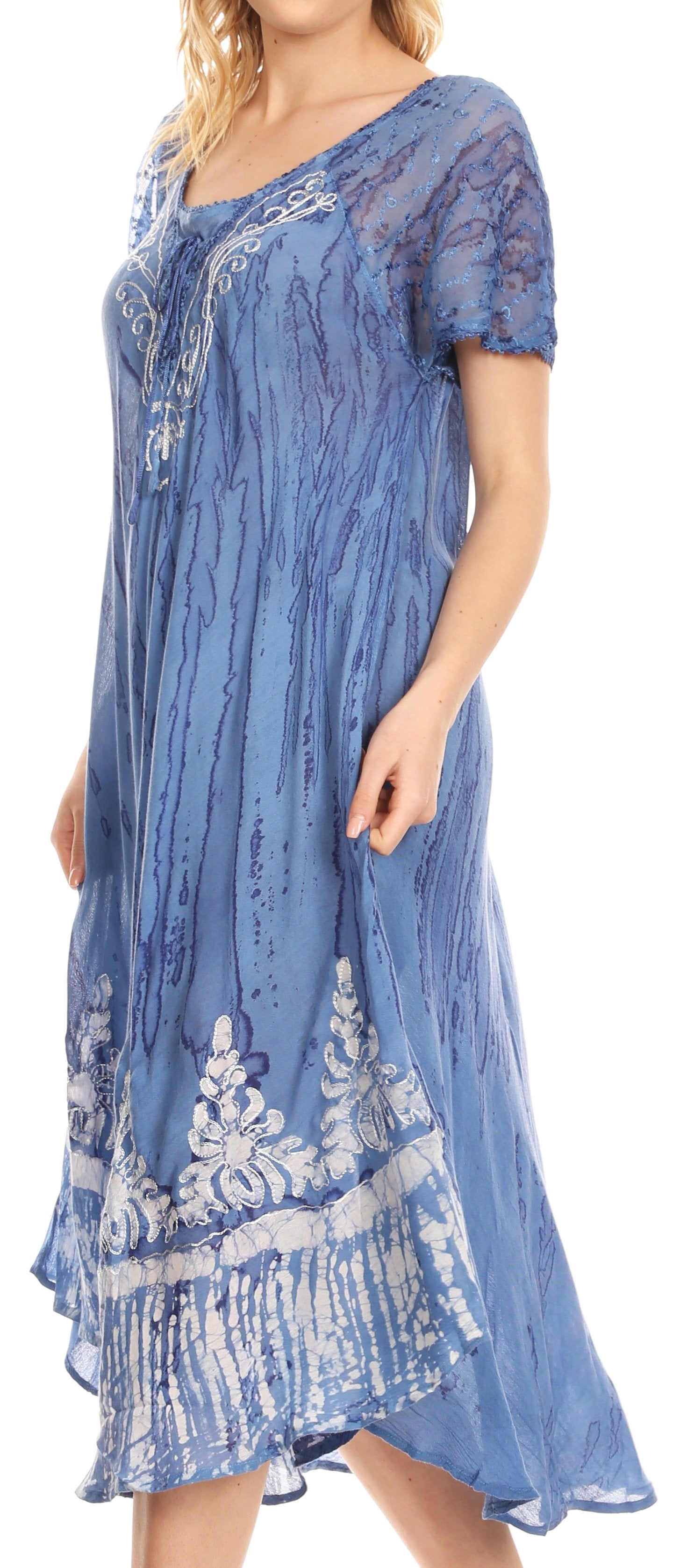 Woman wearing a blue lace dress with white floral patterns