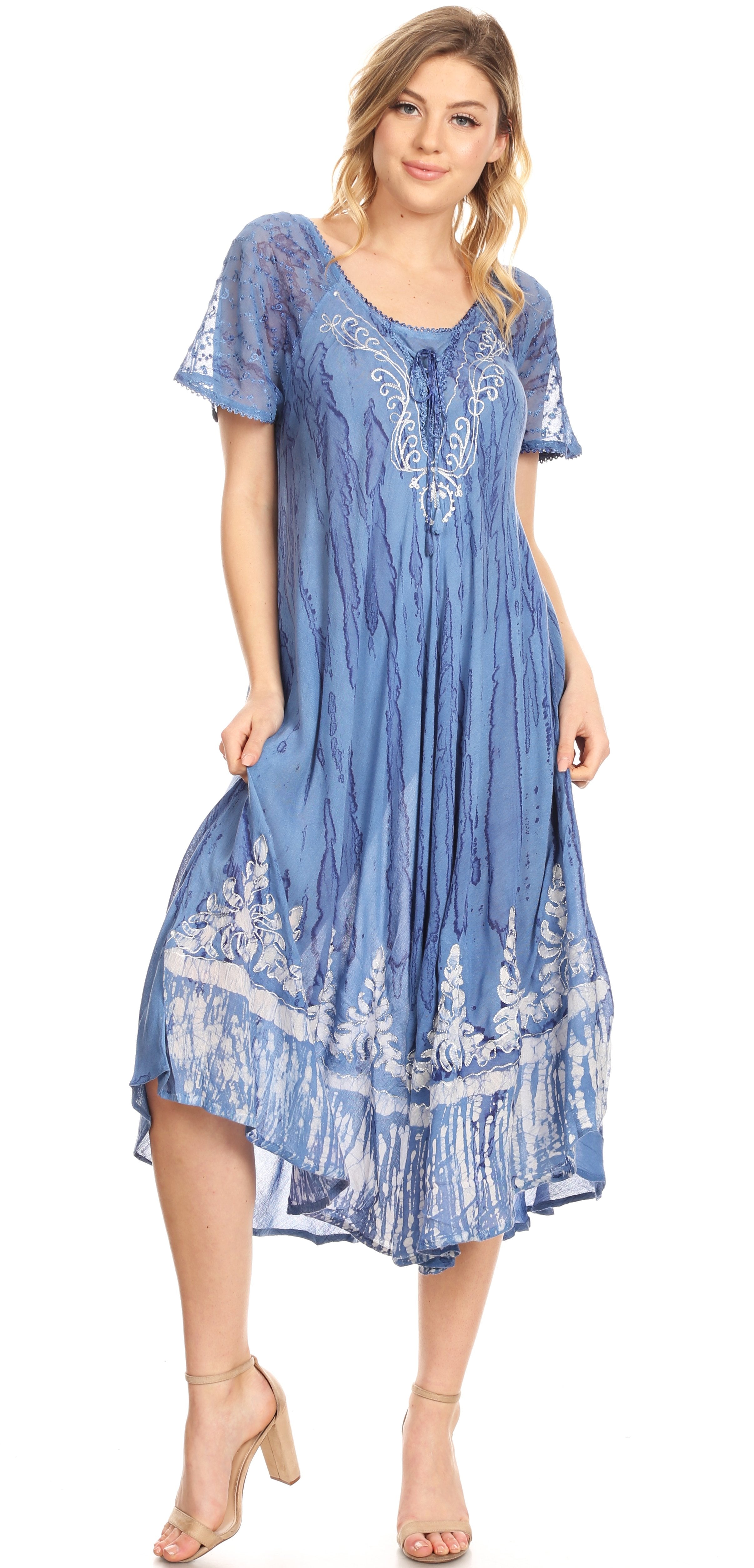 Woman wearing a blue embroidered dress on a white background