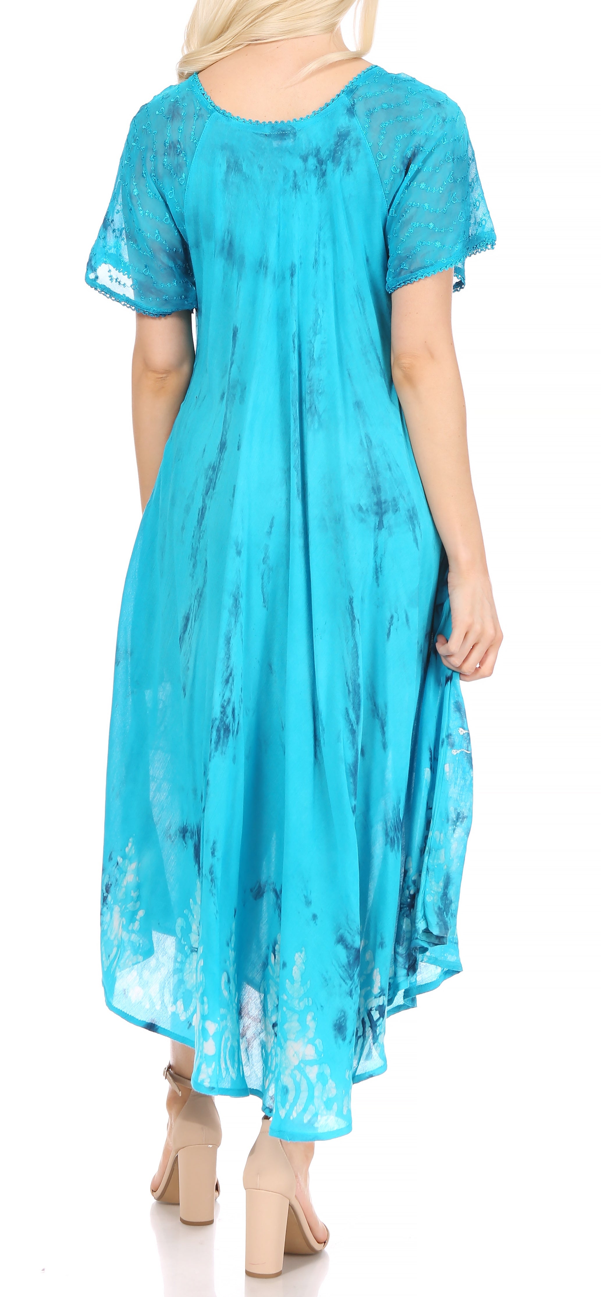 Woman wearing a blue lace dress with a plain background
