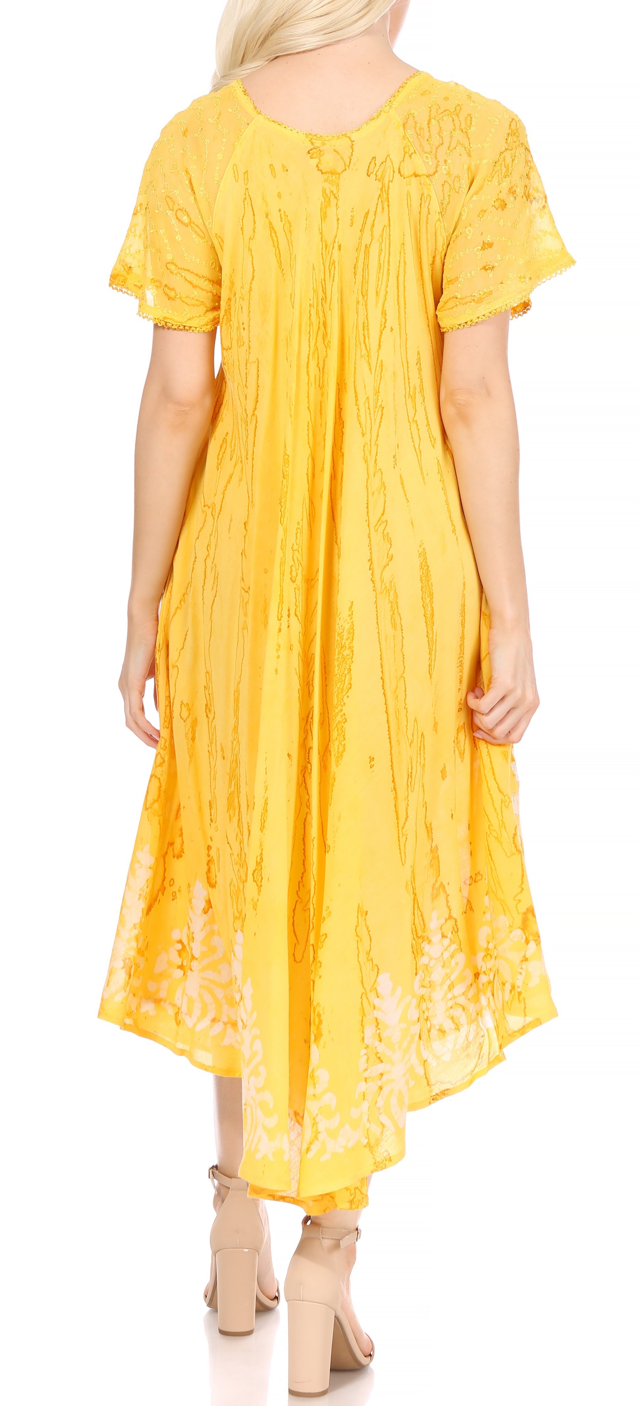 Woman wearing a yellow dress with lace details on a white background