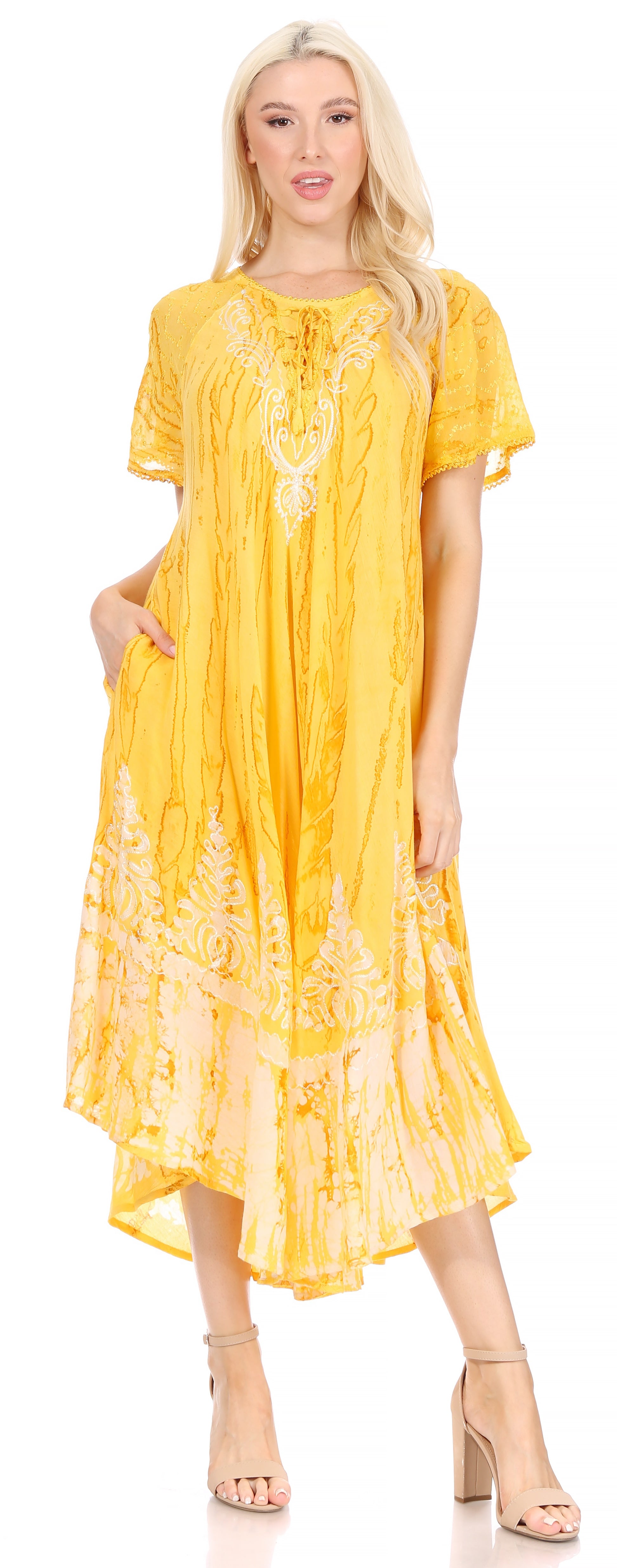 Woman wearing a yellow dress with embroidery on a white background
