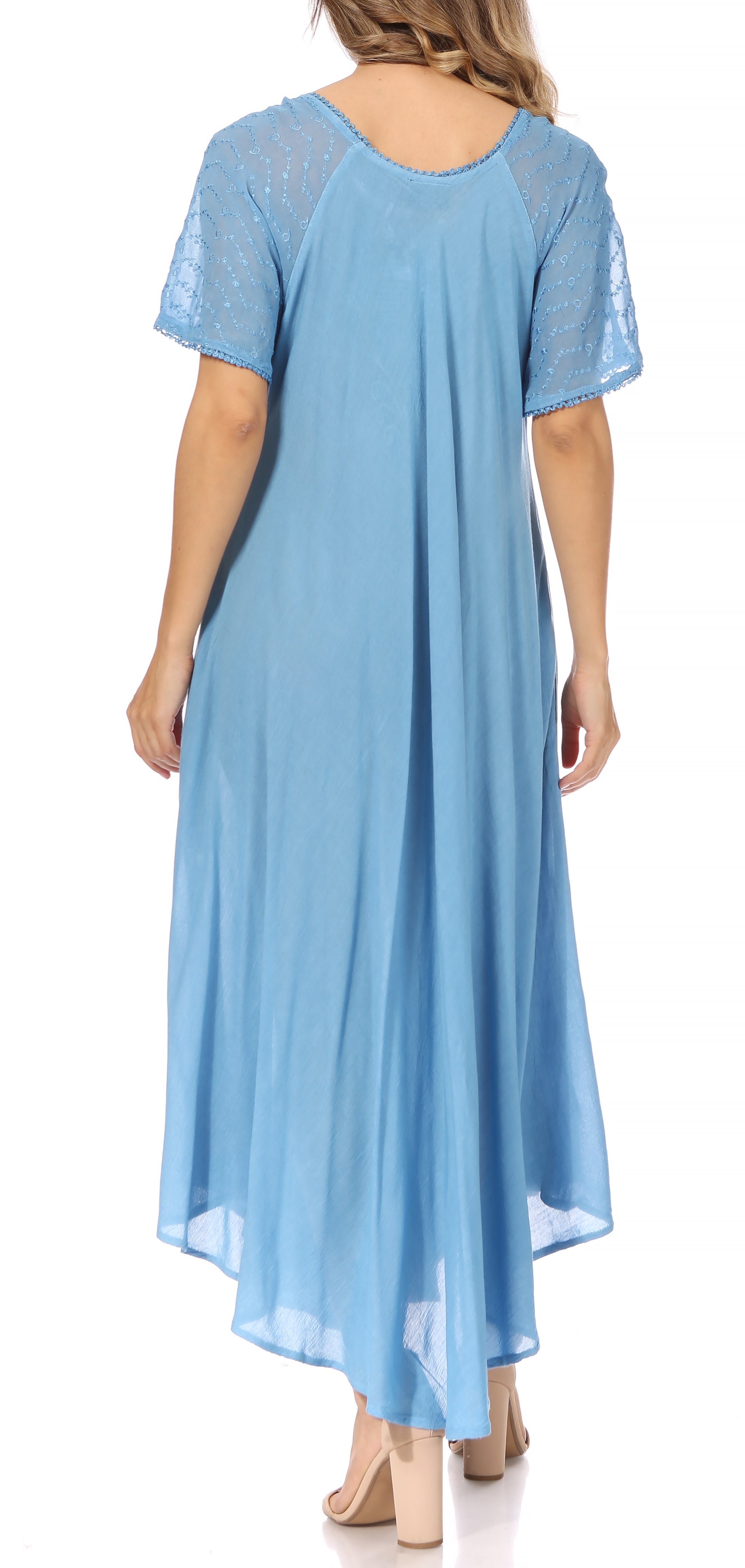 Woman wearing a light blue dress with lace sleeves on a white background