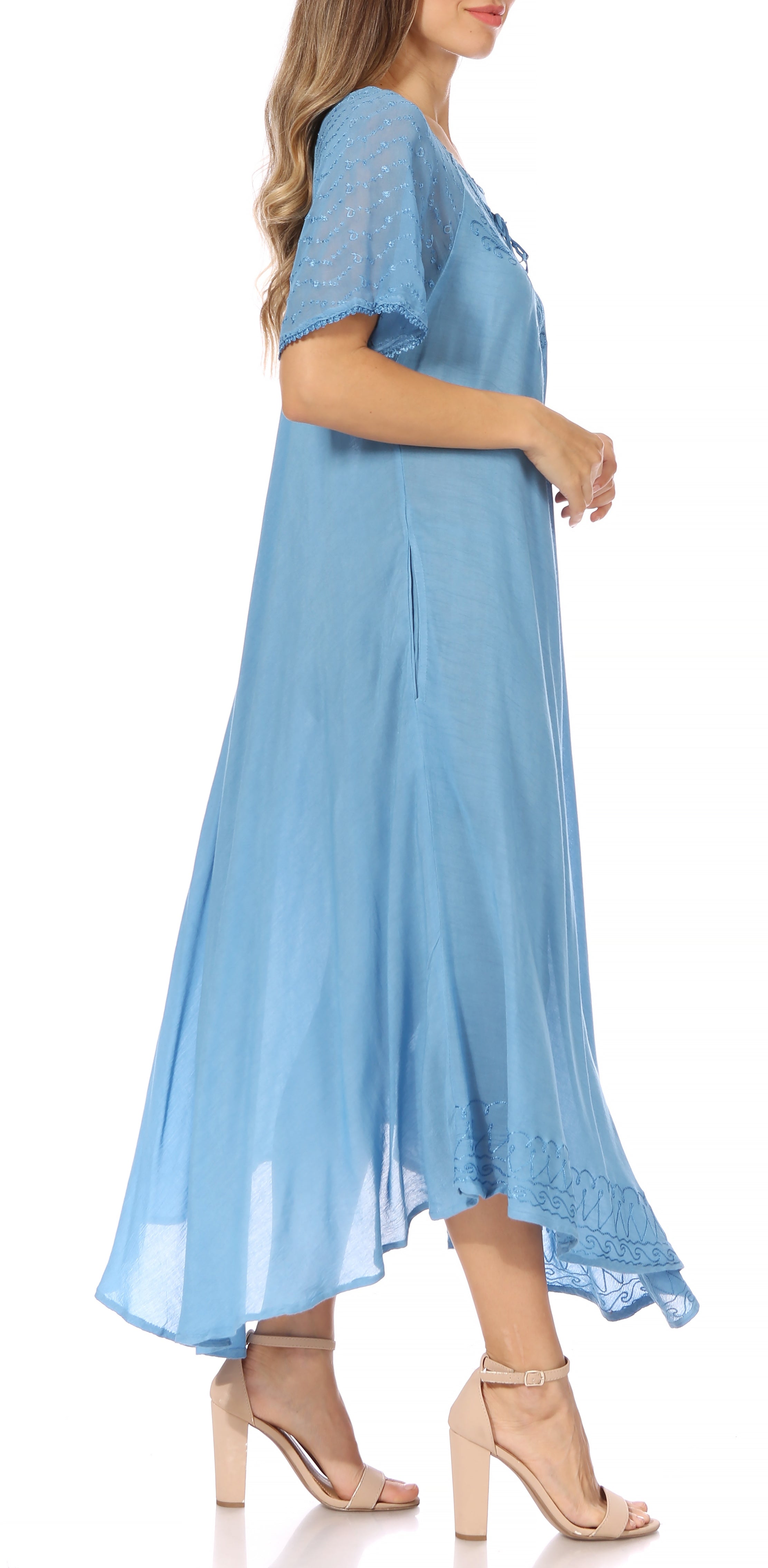 Woman wearing a light blue dress with a white background