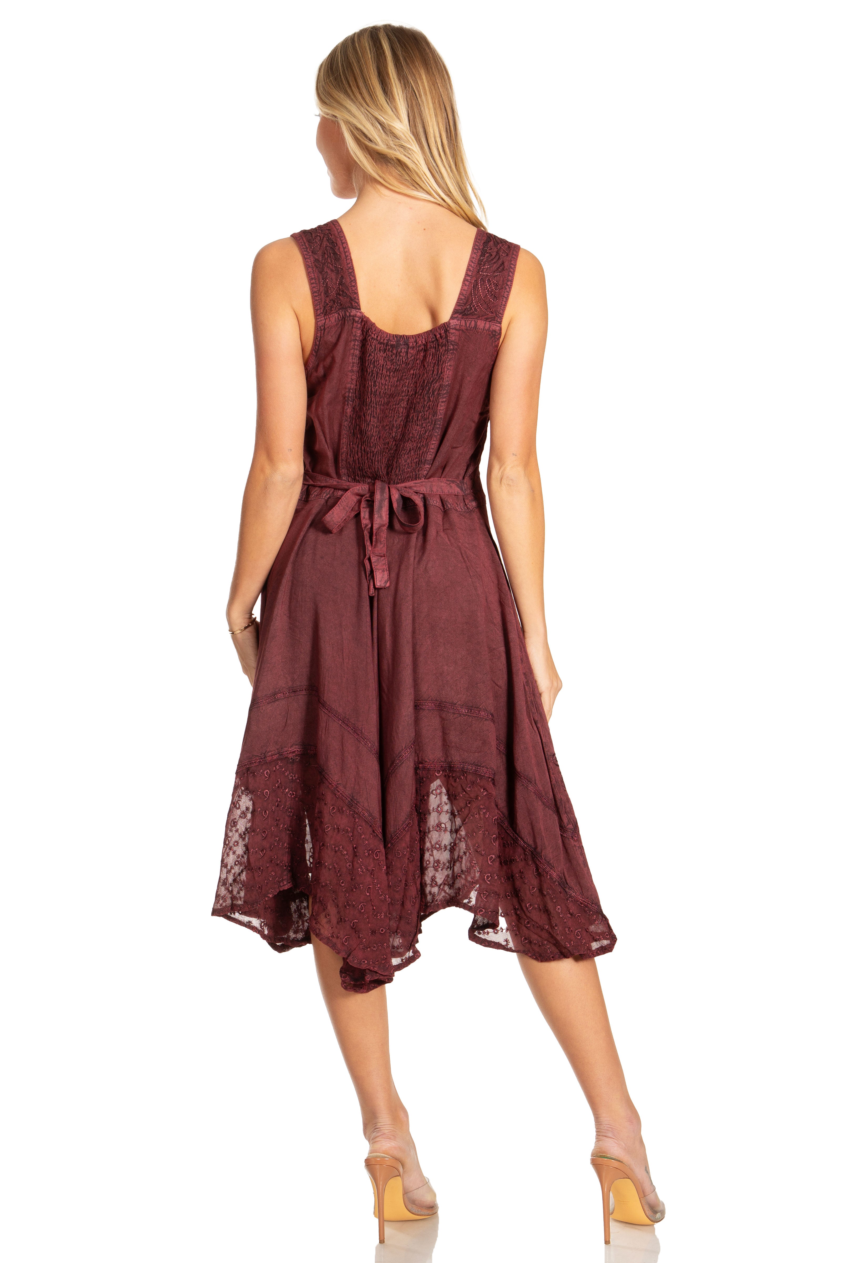 Woman wearing a burgundy dress with lace details on a white background