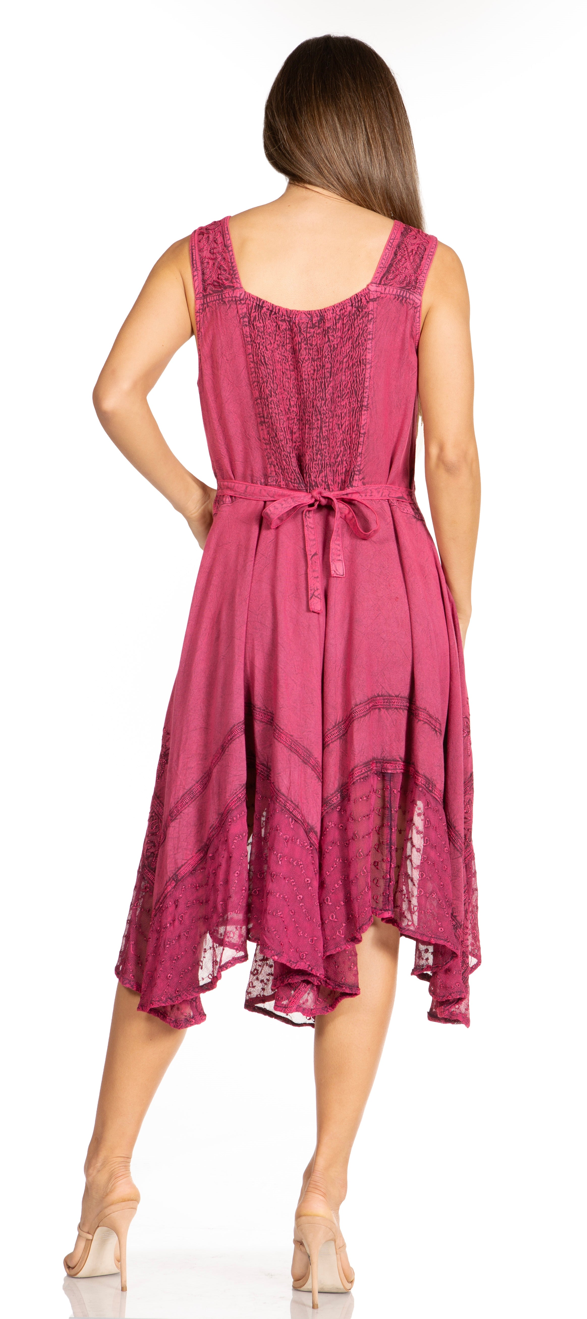 Woman wearing a pink dress with lace details on a white background
