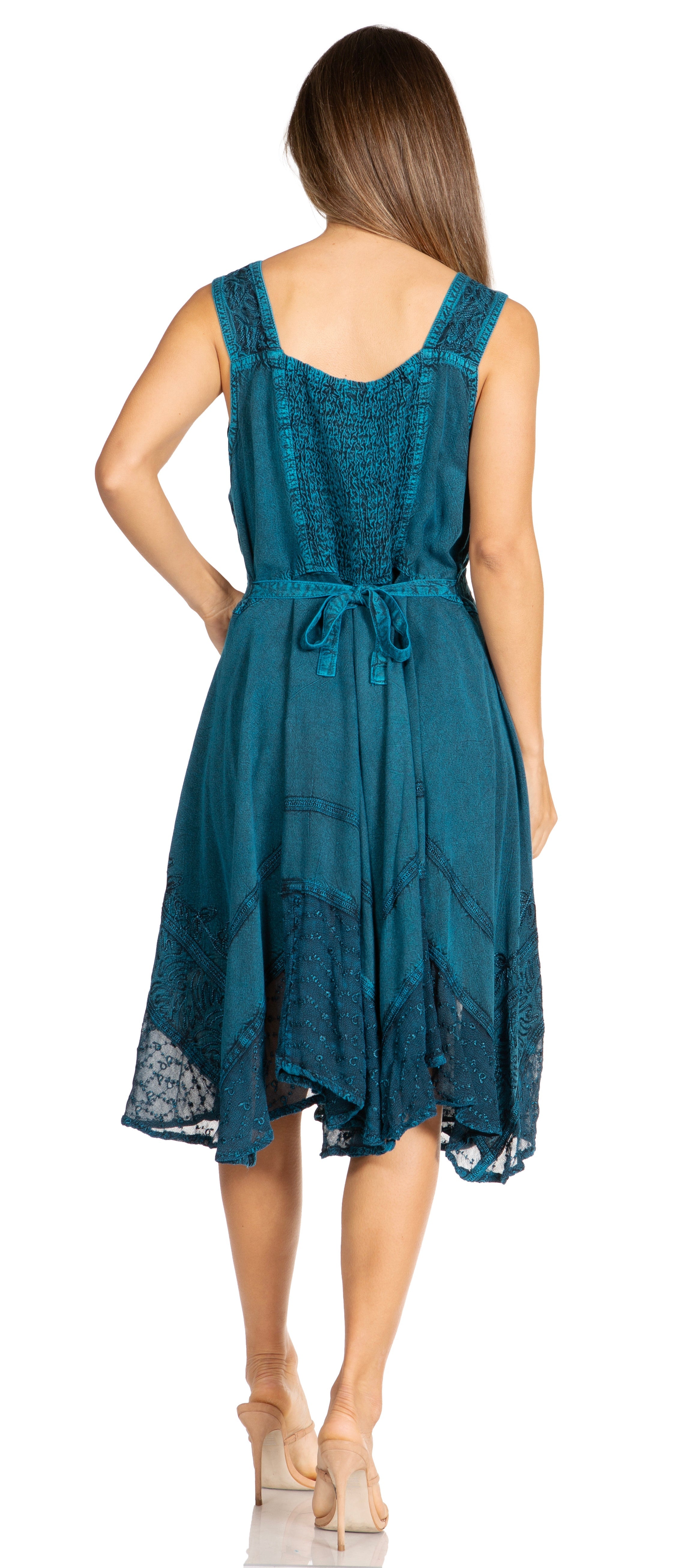 Woman wearing a teal dress with a white background