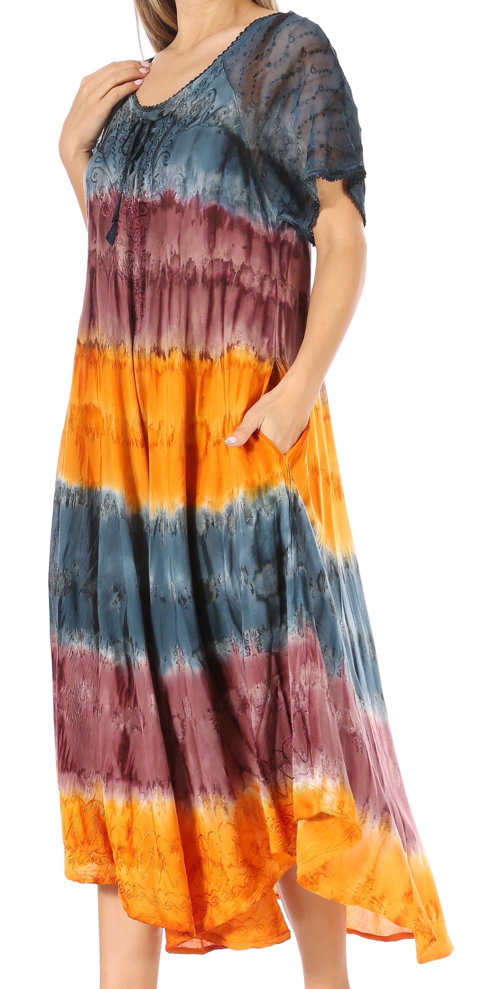 Woman wearing a tie-dye dress with blue, orange, and purple colors on a white background.