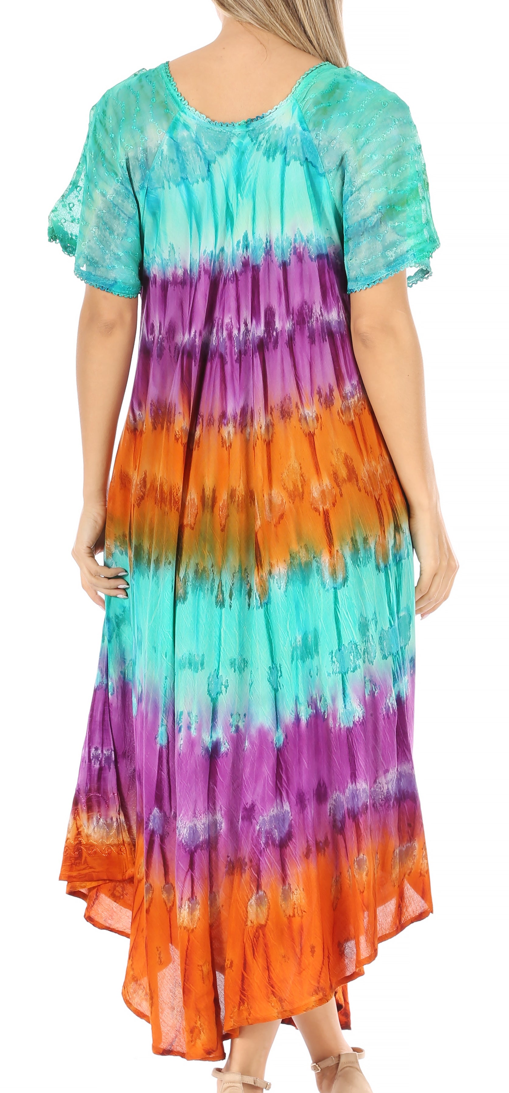 Woman wearing a colorful tie-dye dress with a gradient from green to orange.