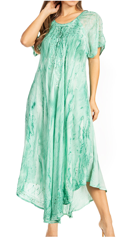 Woman wearing a green patterned dress on a white background