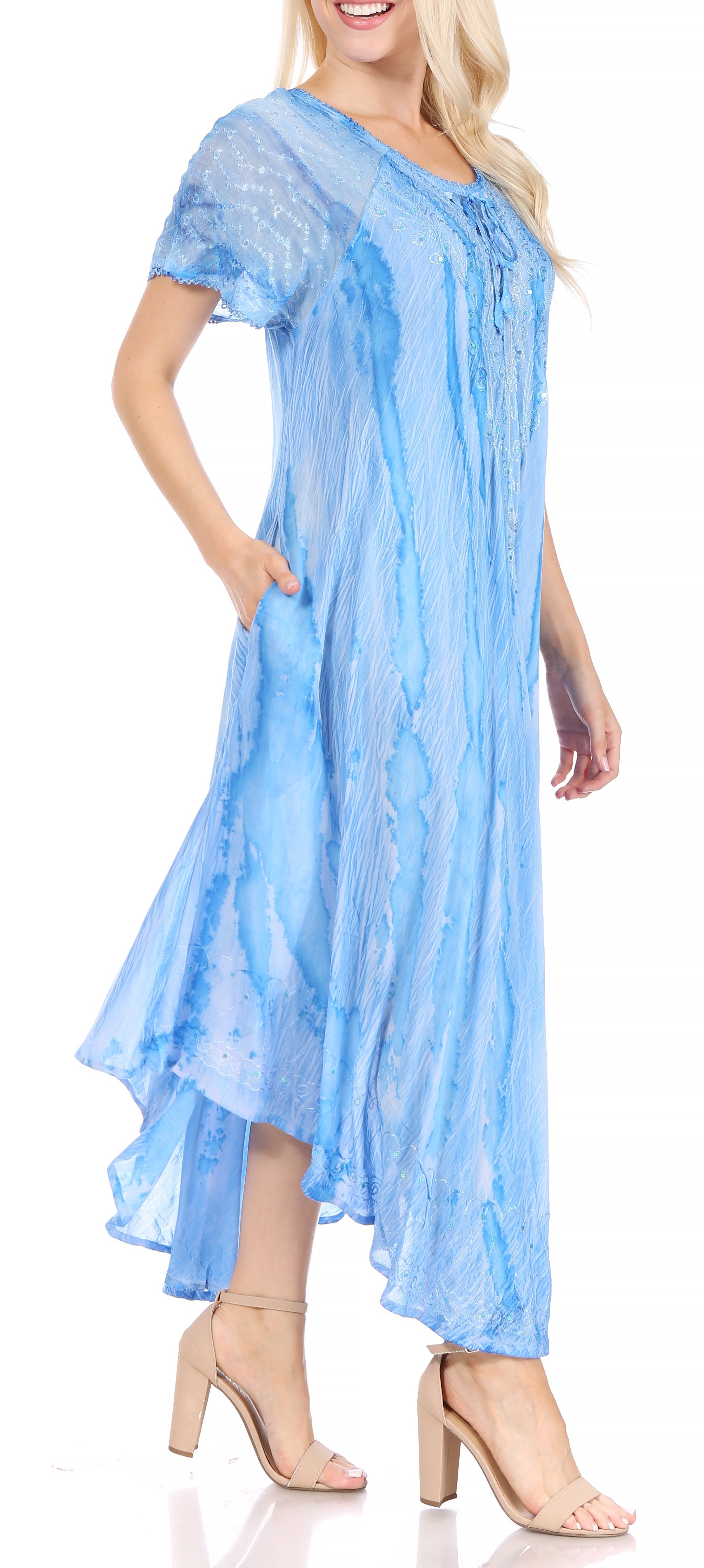 Woman wearing a light blue dress with a plain background