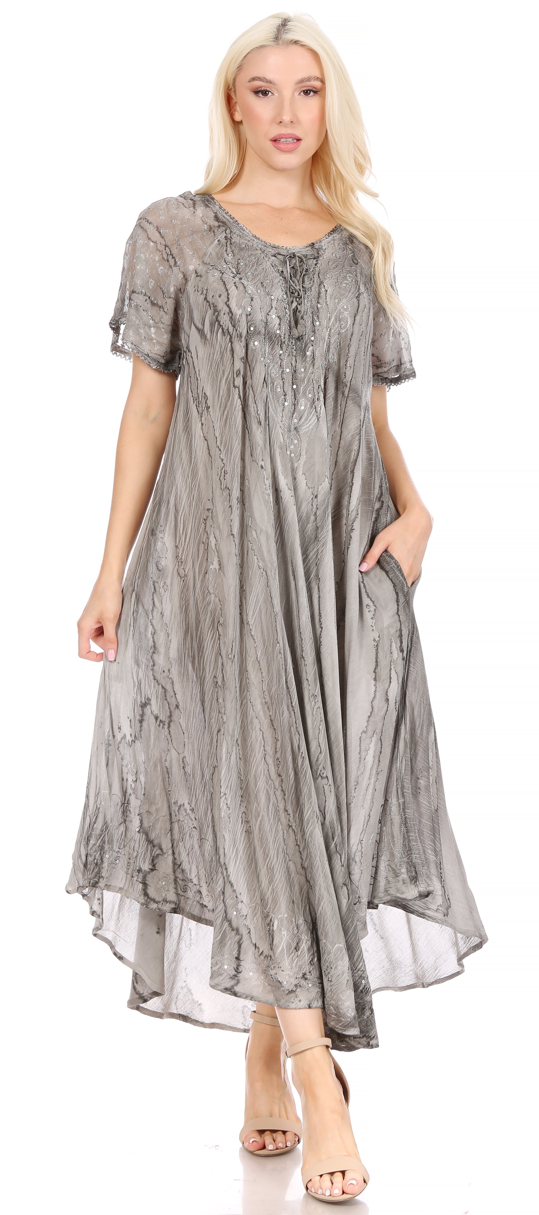 Woman wearing a long, patterned dress on a white background