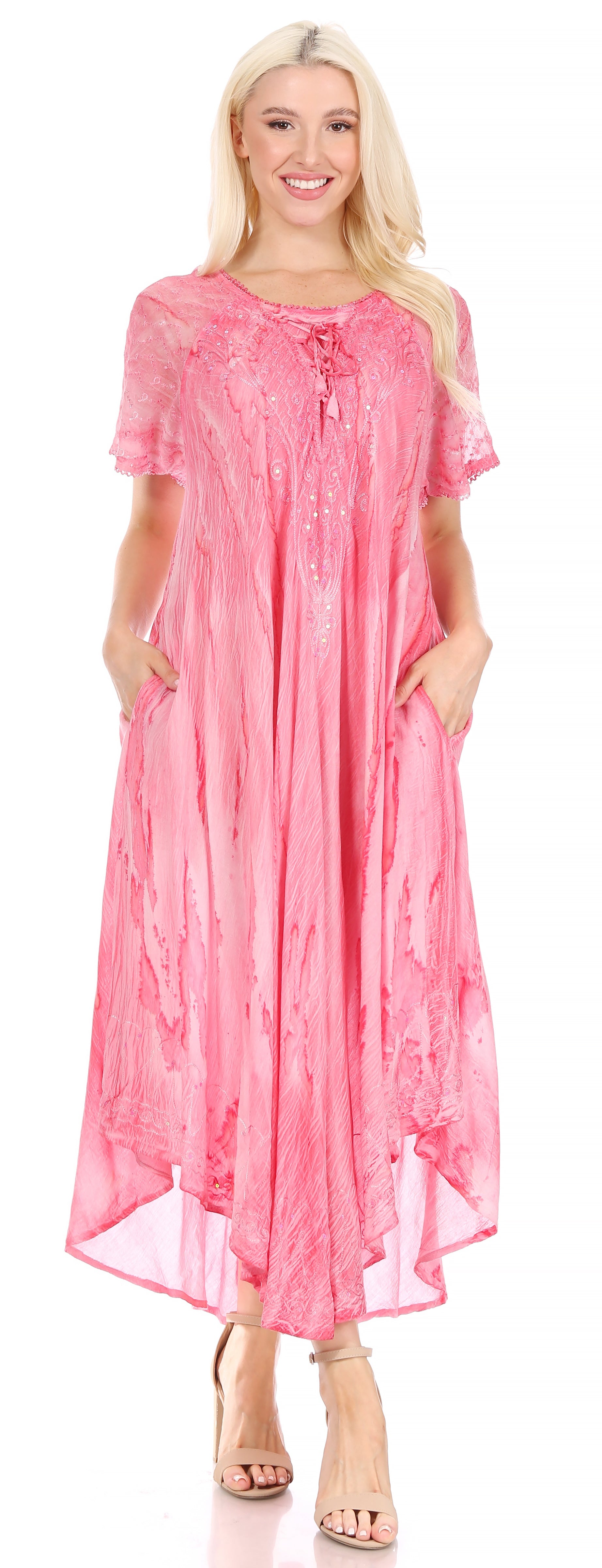 Woman wearing a pink dress with a floral pattern on a white background