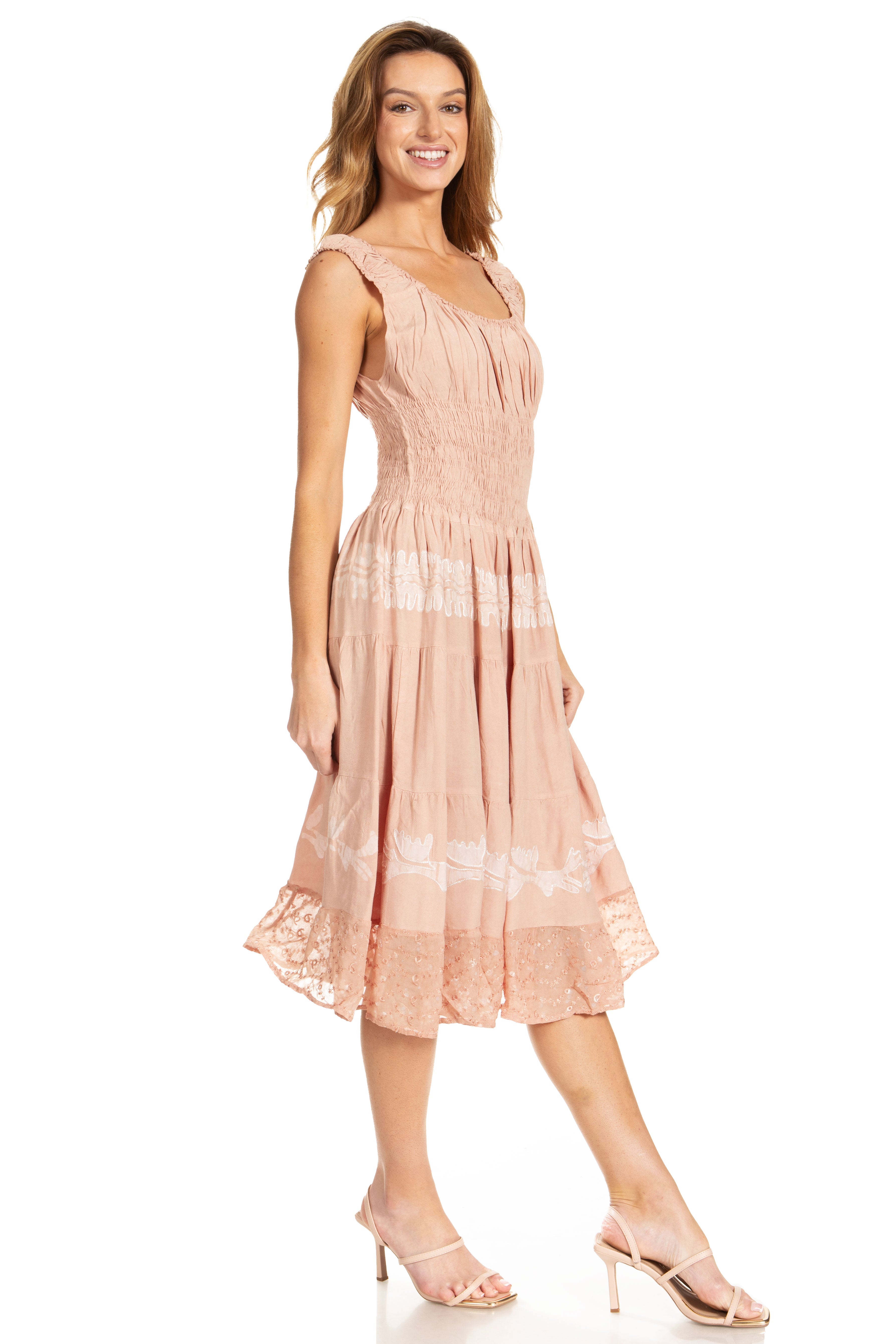 Woman wearing a pink dress with floral patterns on a white background