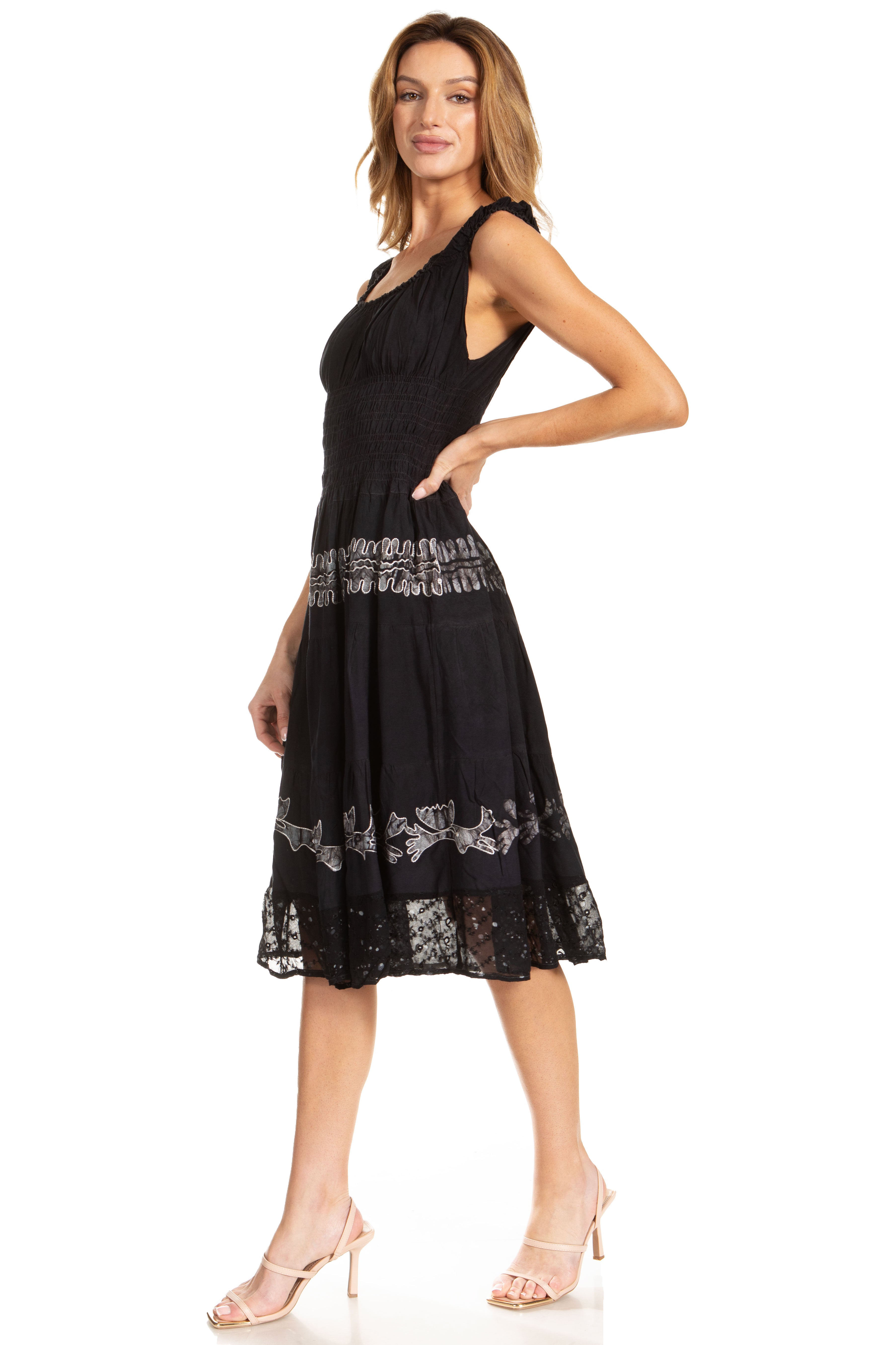 Woman wearing a black dress with lace details on a white background