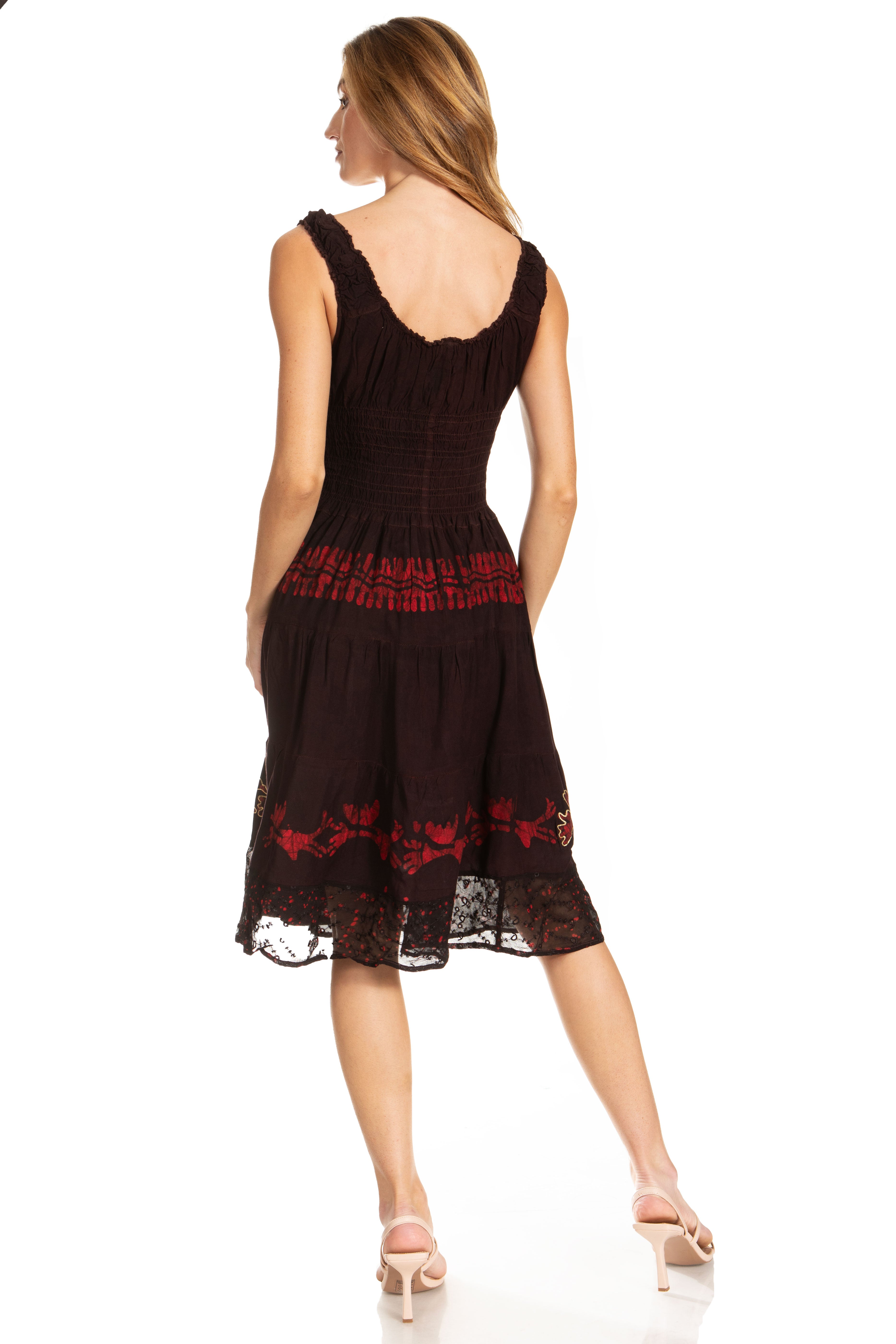 Woman wearing a black dress with red embroidery on a white background