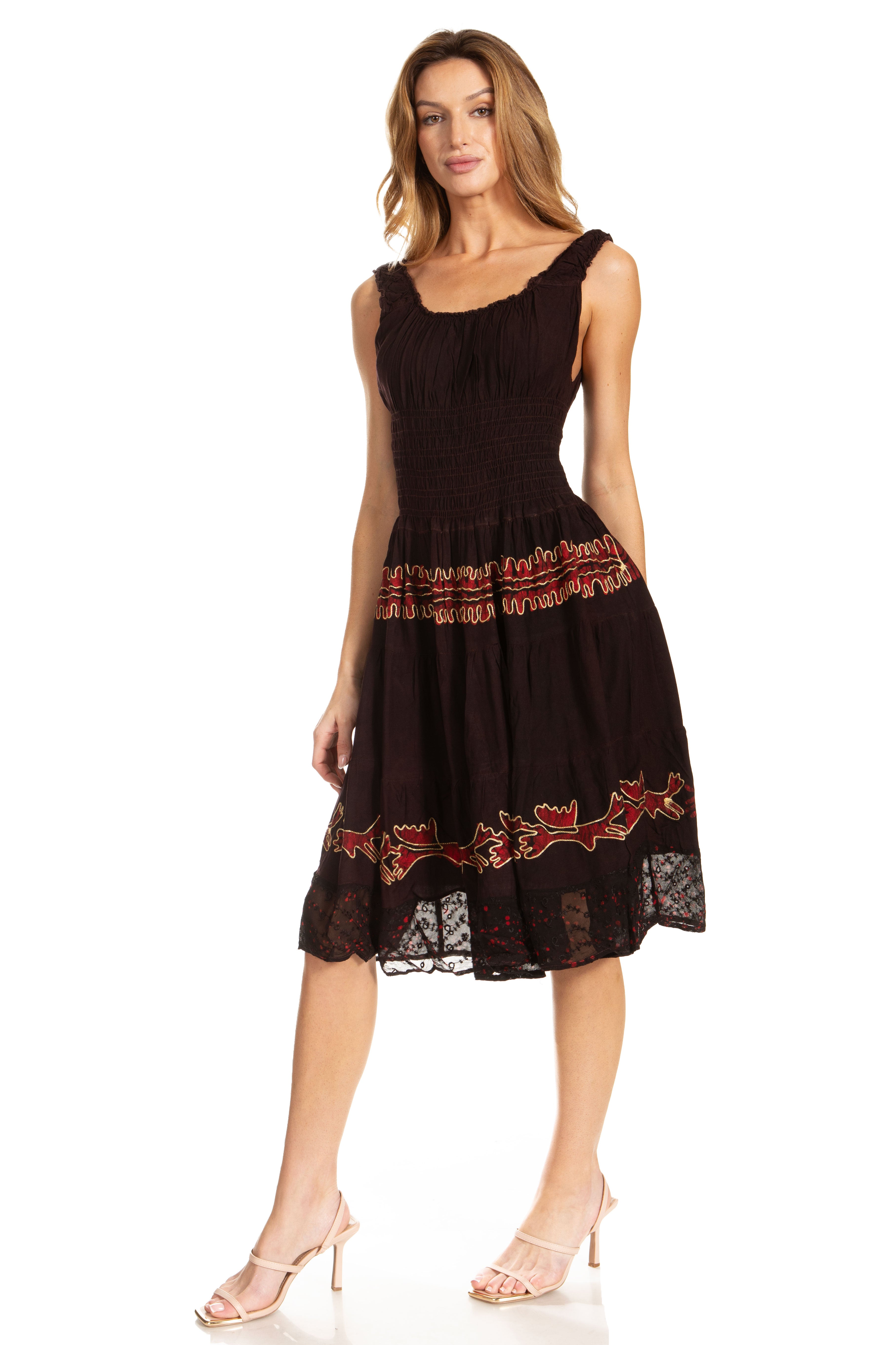 Woman wearing a black dress with red floral embroidery on a white background
