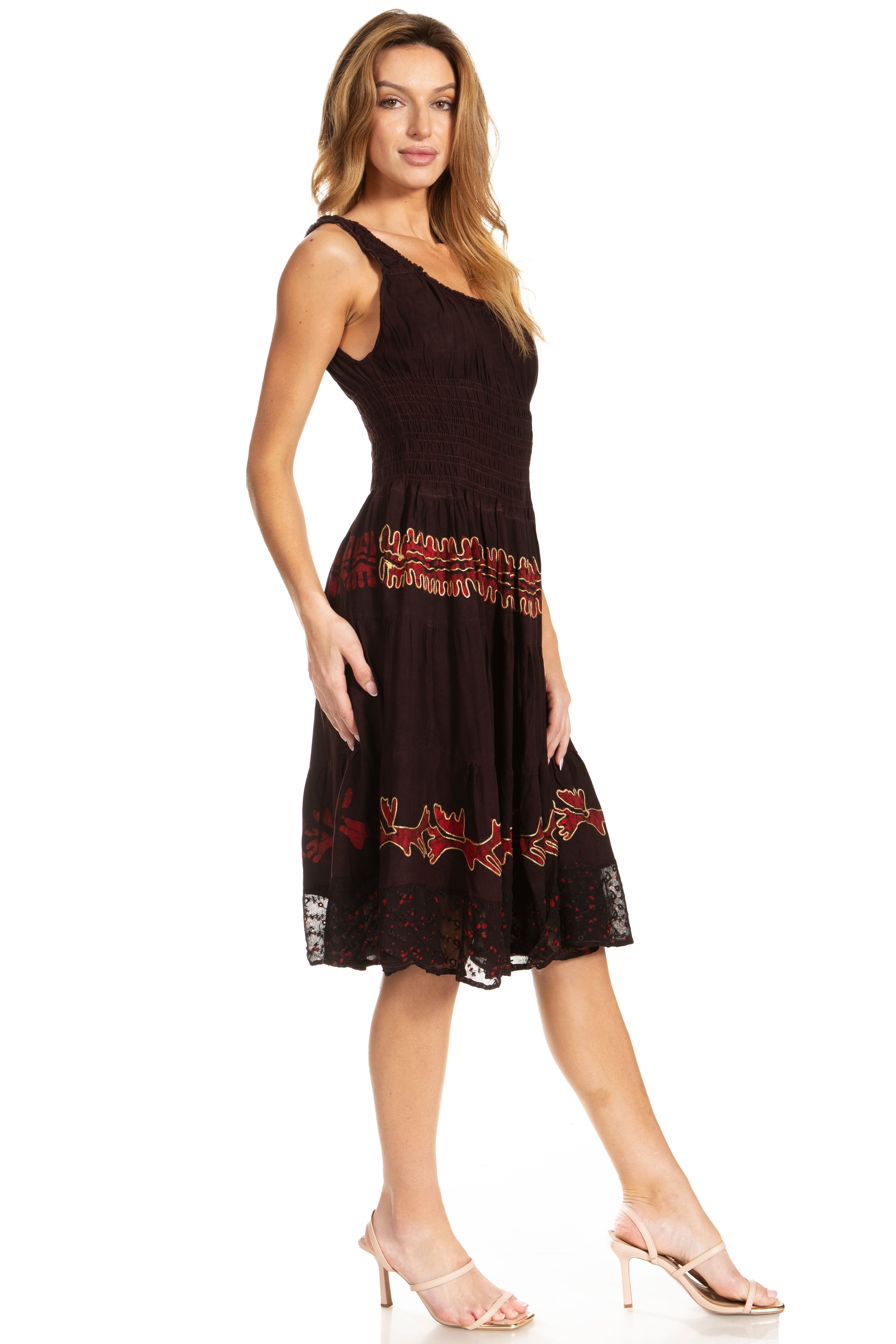 Woman wearing a black dress with red embroidery on a white background