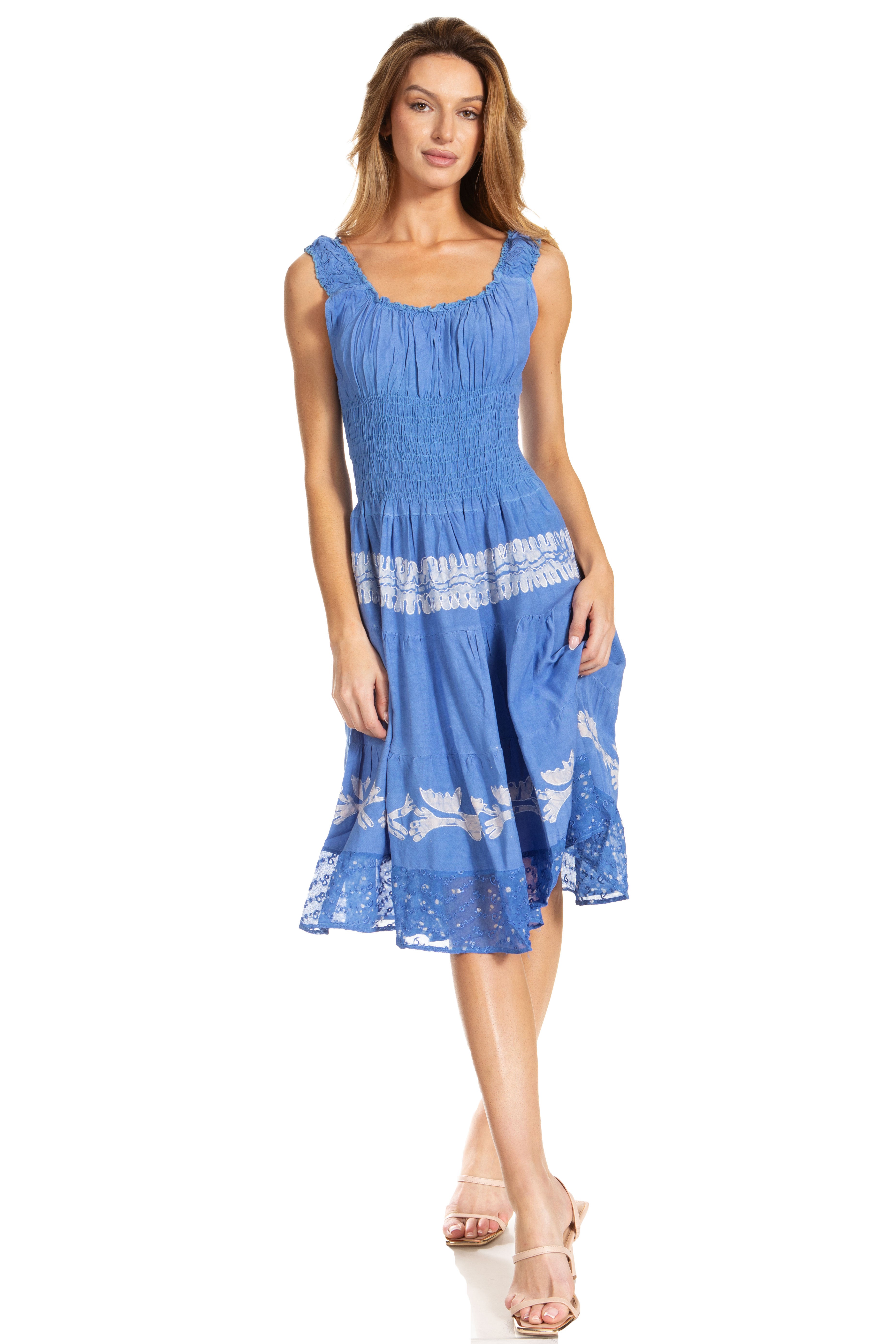 Woman wearing a blue dress with white lace details on a white background