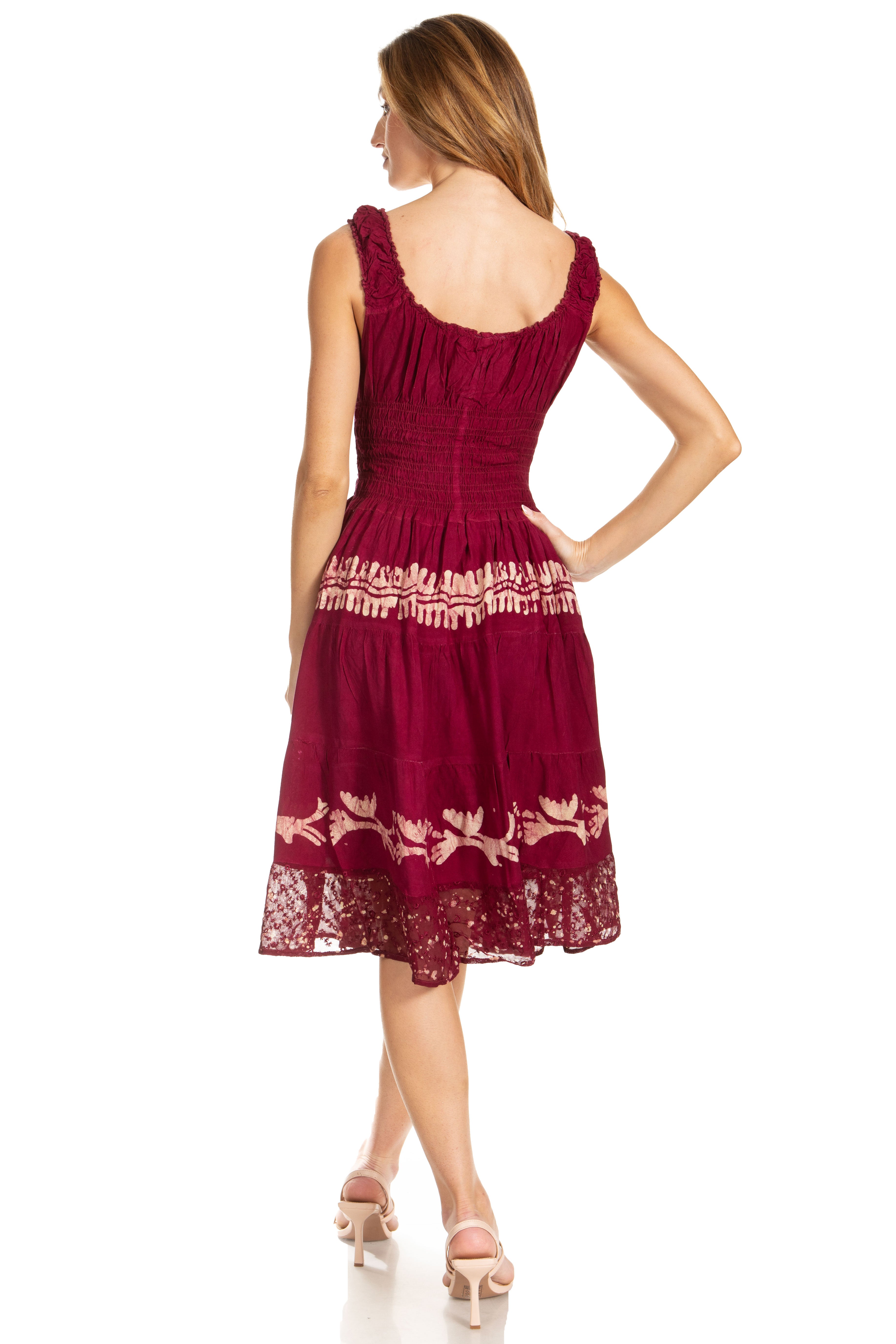 Woman wearing a burgundy dress with lace details on a white background