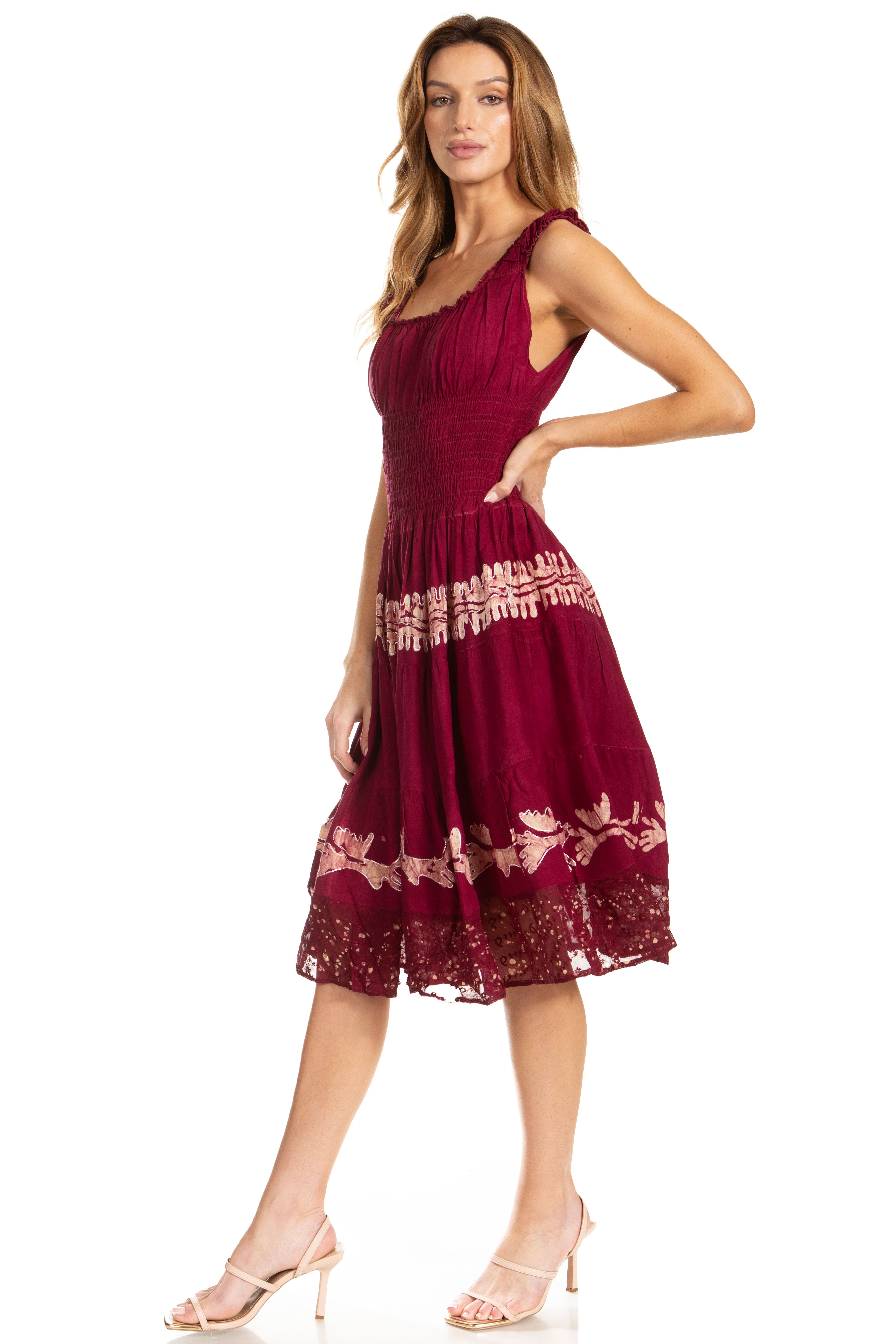 Woman wearing a burgundy dress with lace details on a white background