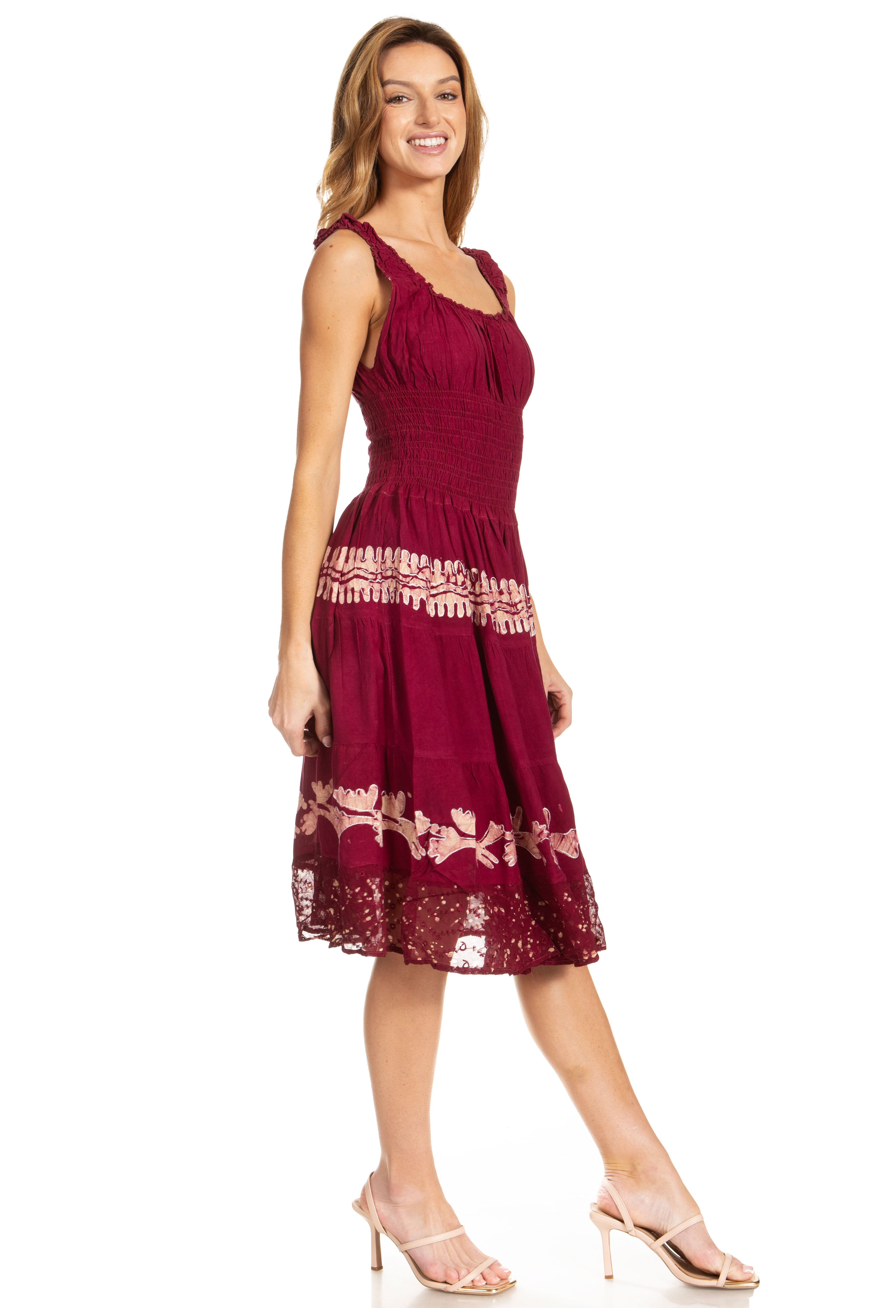 Woman wearing a burgundy dress with lace details on a white background