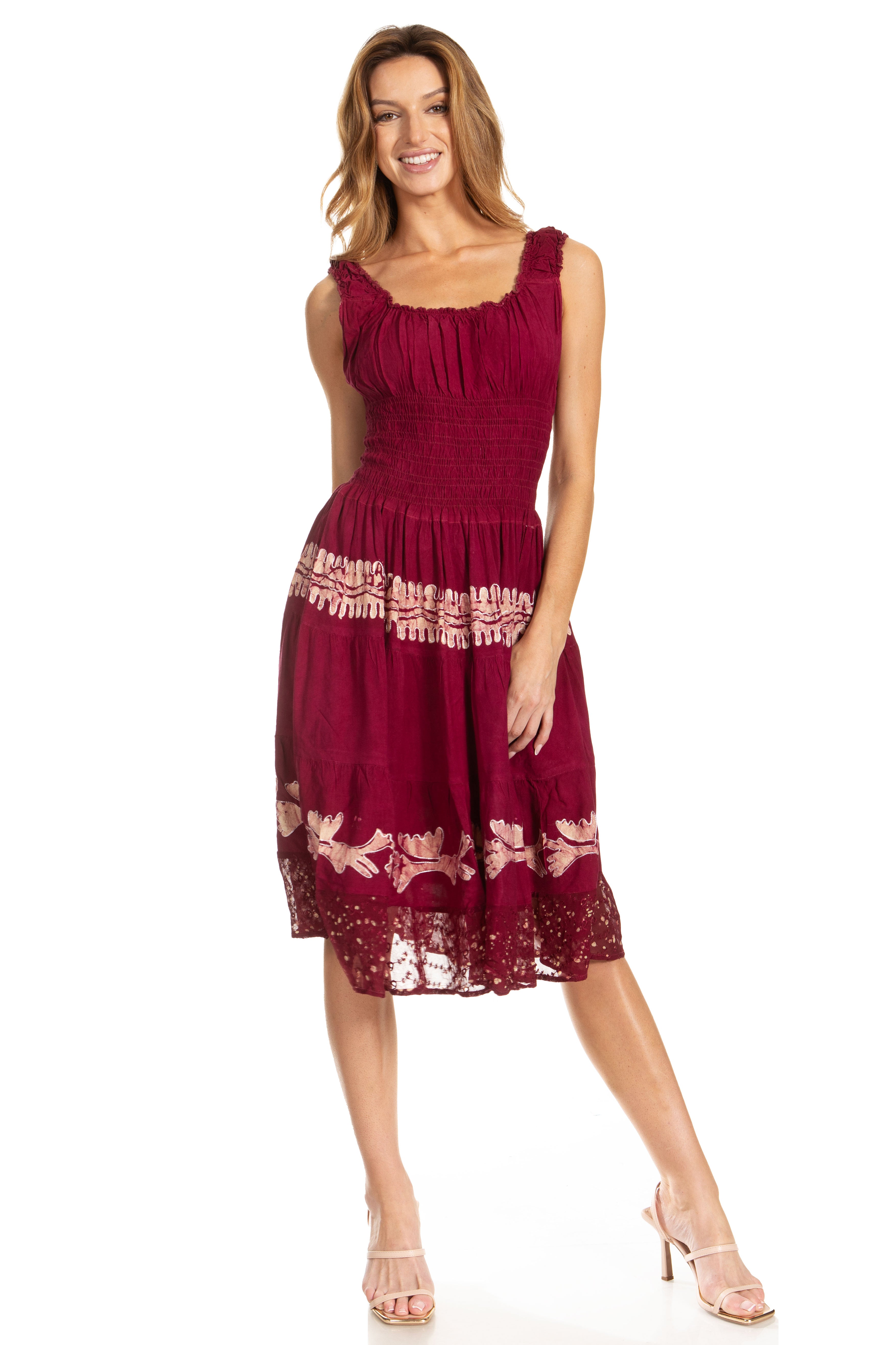 Woman wearing a burgundy dress with lace details on a white background