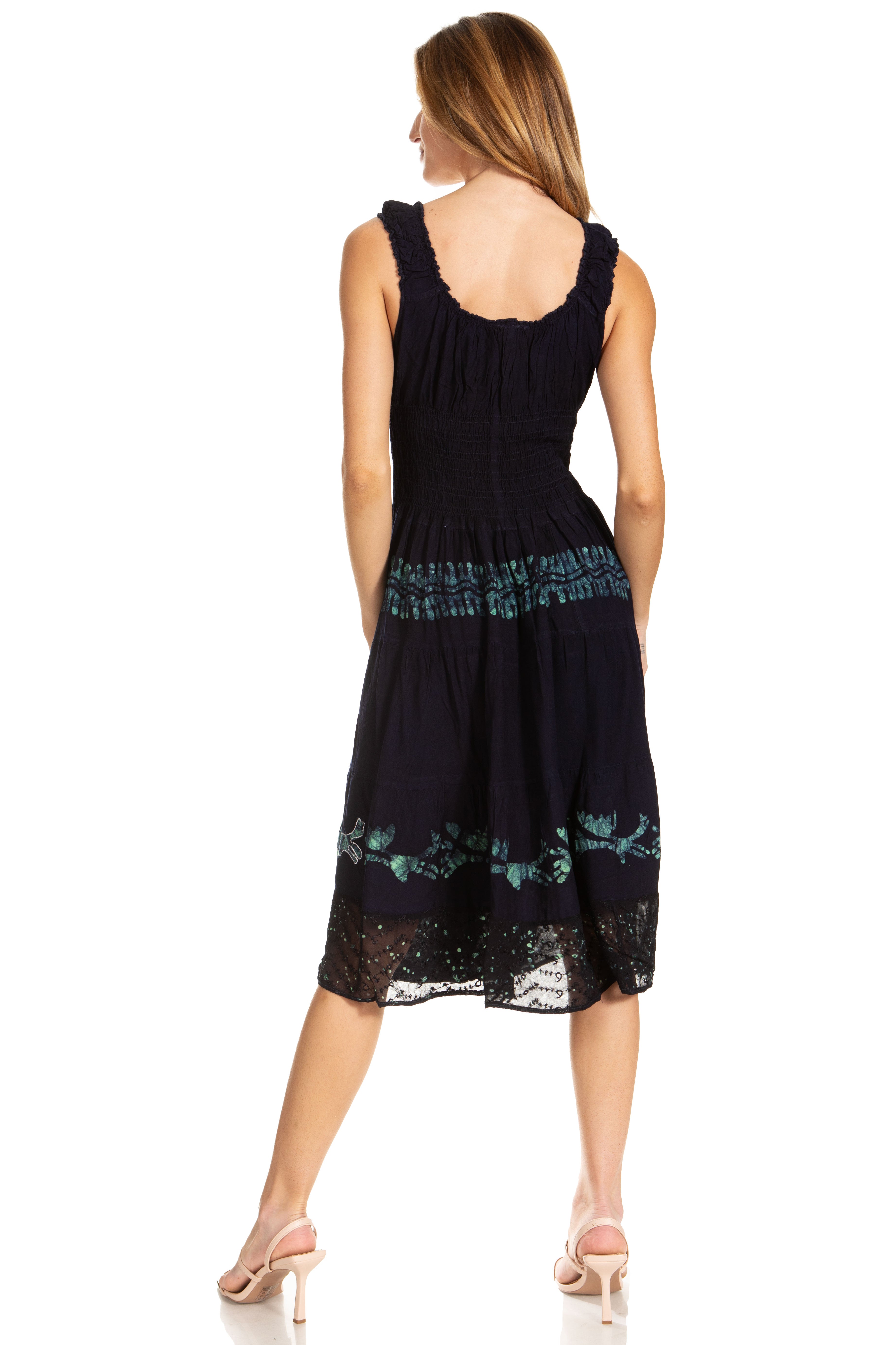 Woman wearing a black dress with floral patterns on a white background