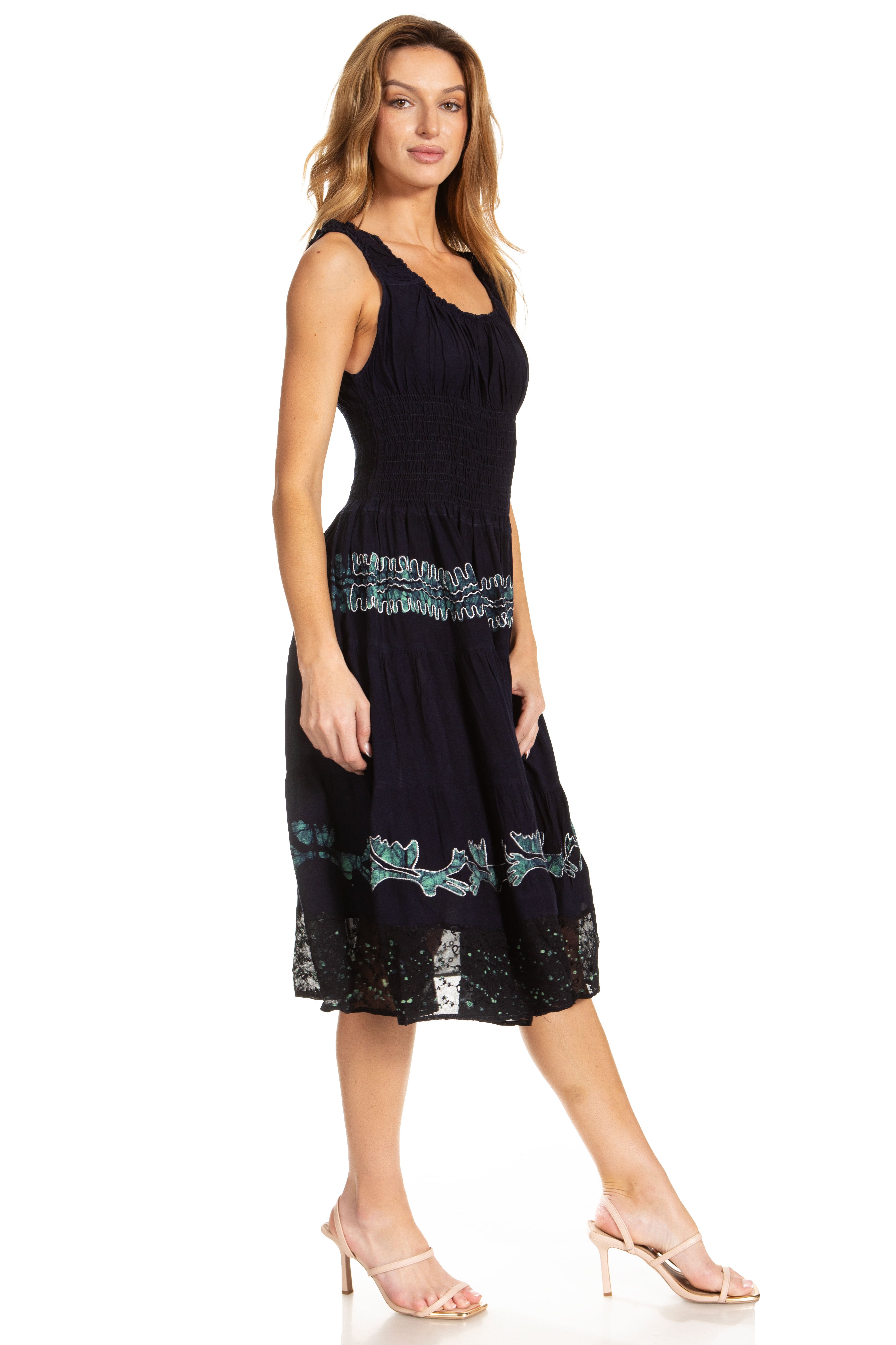 Woman wearing a black dress with white patterns on a white background