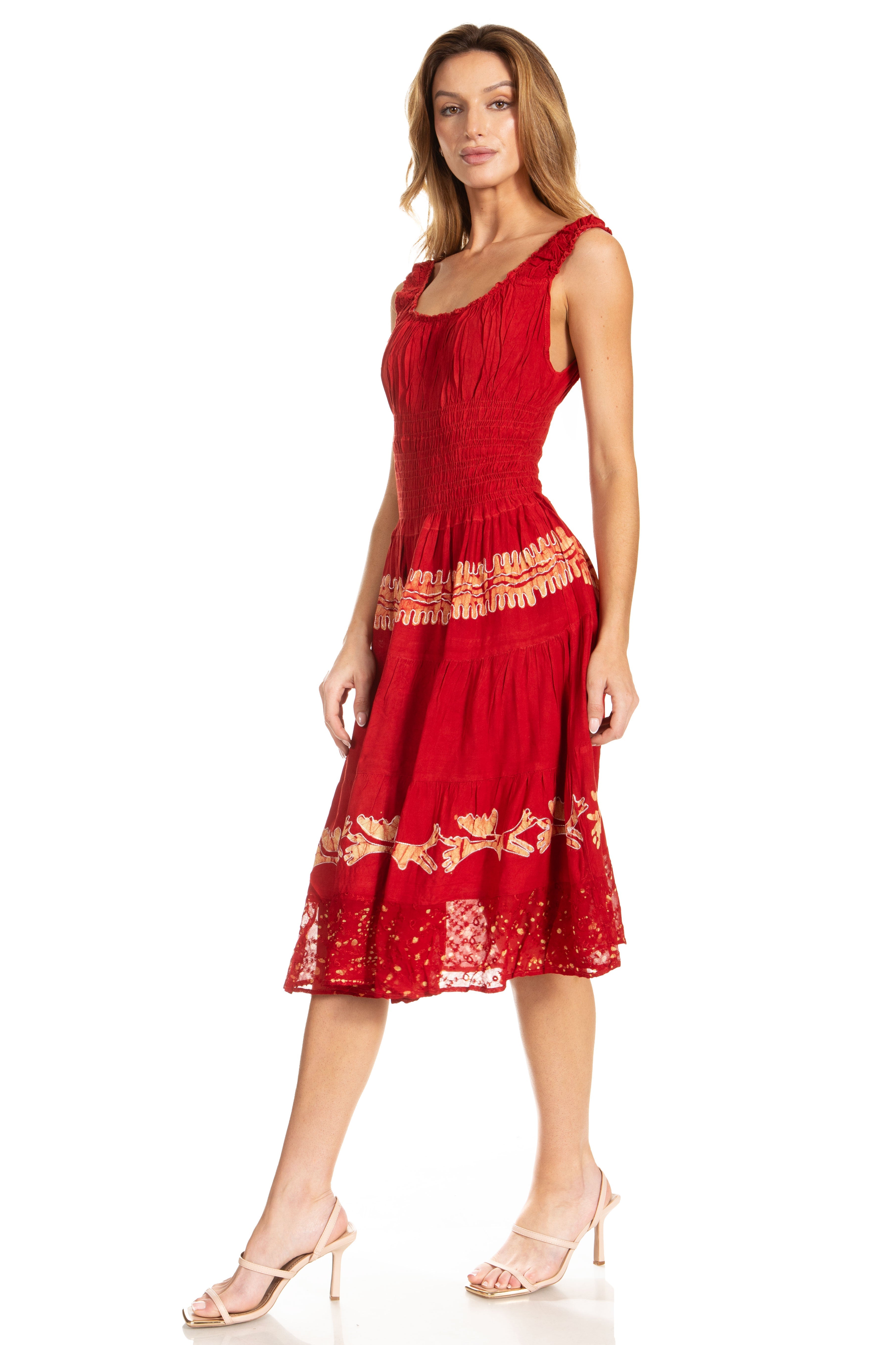 Woman wearing a red dress with gold embroidery on a white background