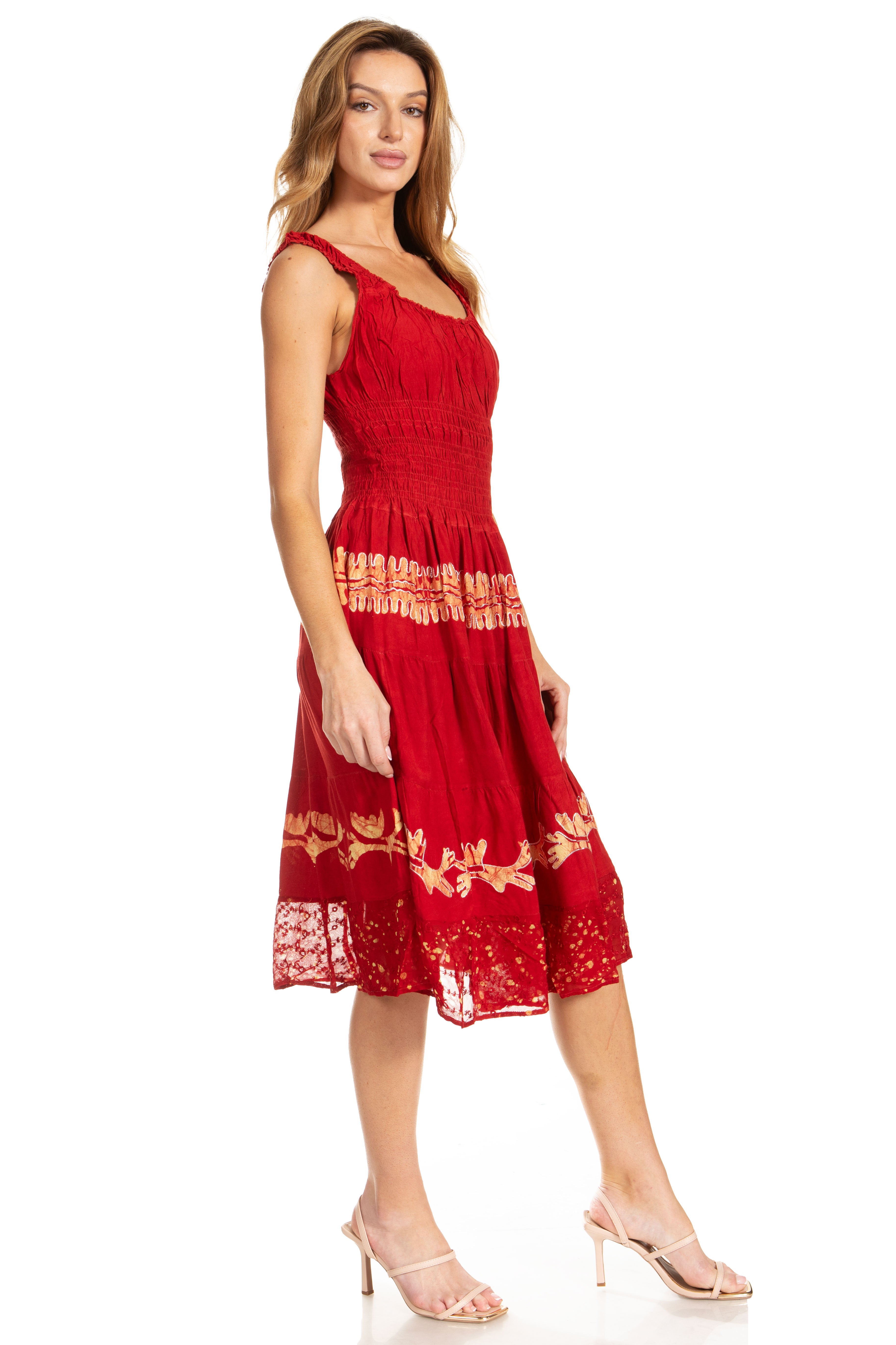 Woman wearing a red dress with gold lace details on a white background