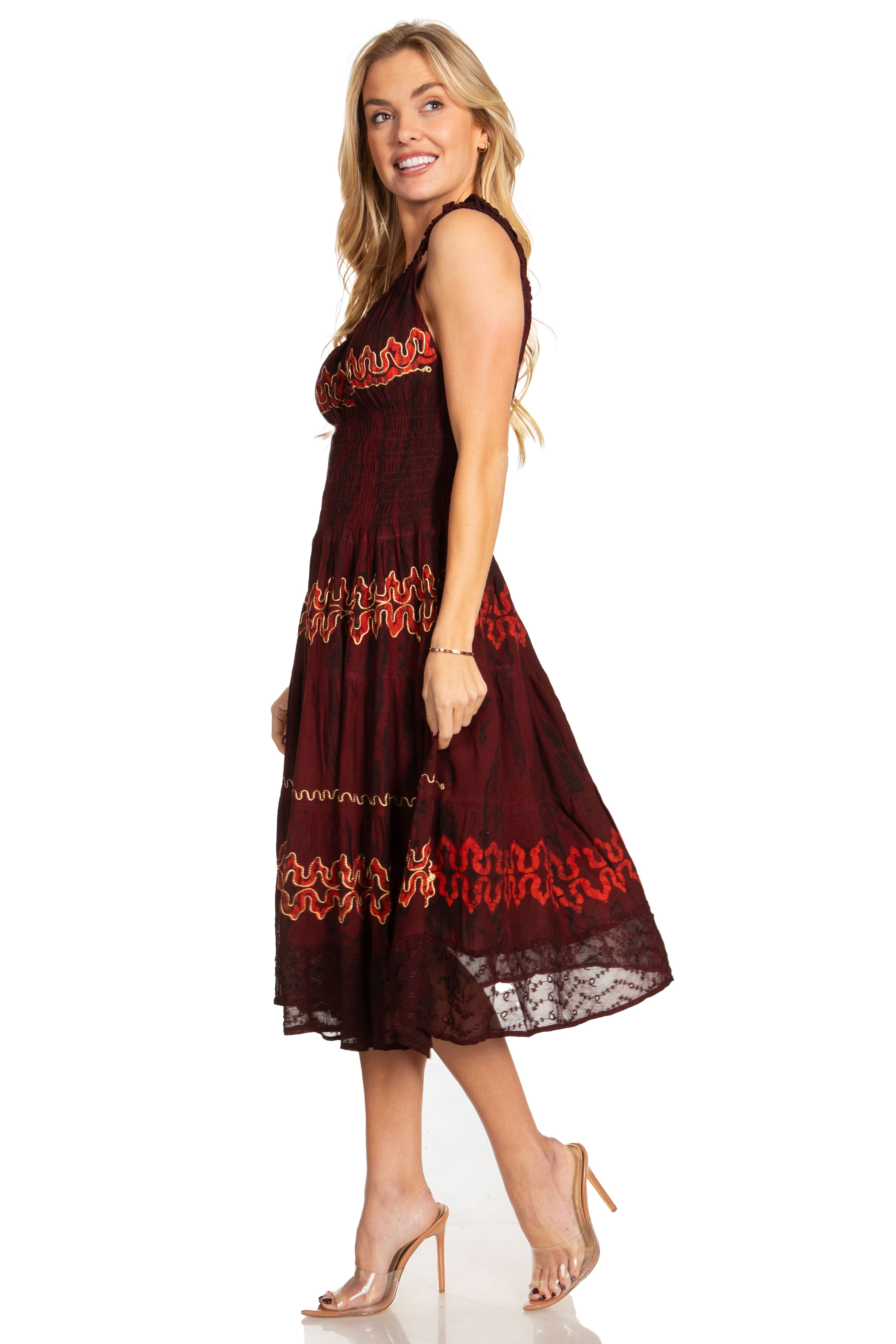 Woman wearing a burgundy dress with red lace details on a white background