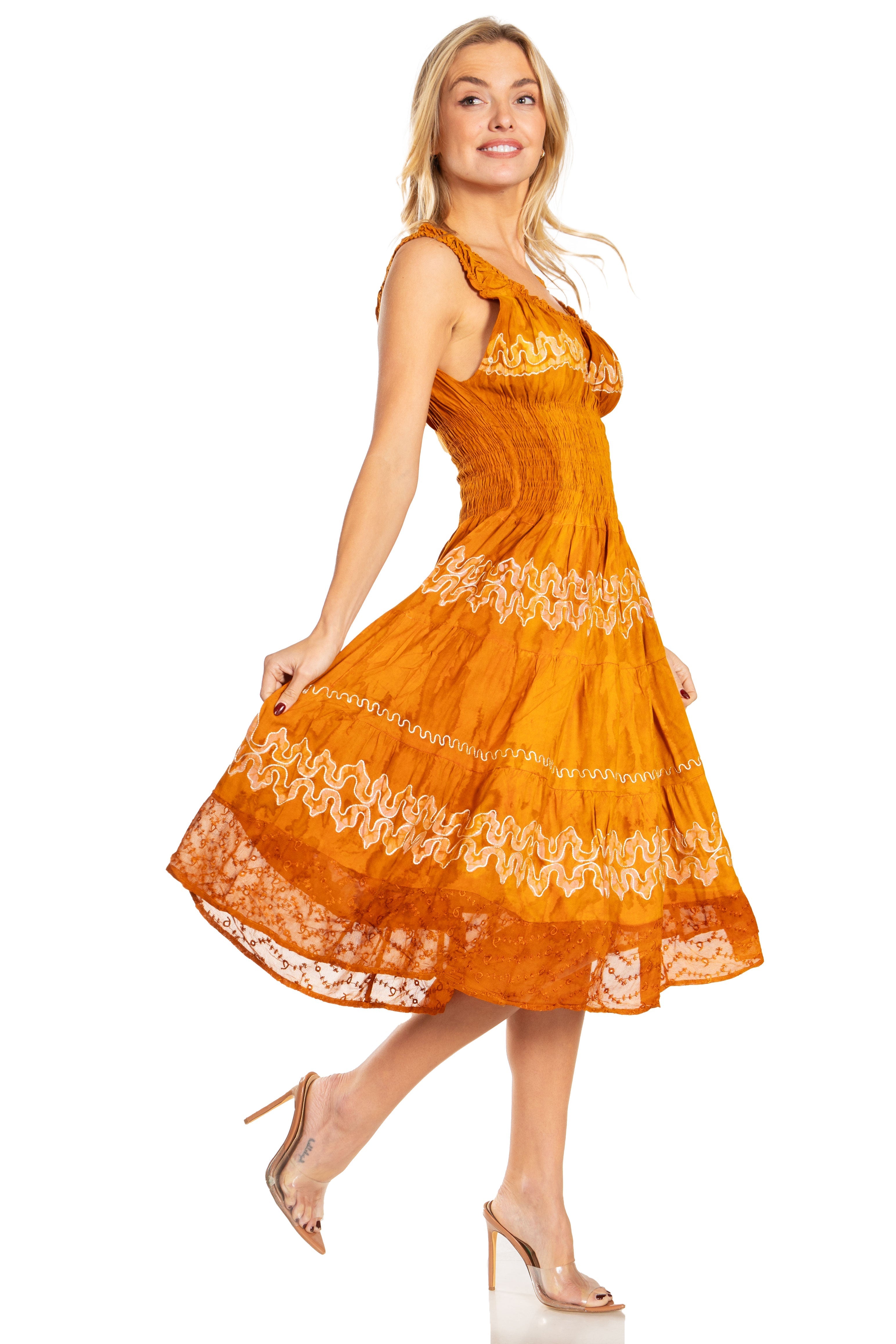 Woman wearing an orange dress with white lace details on a white background