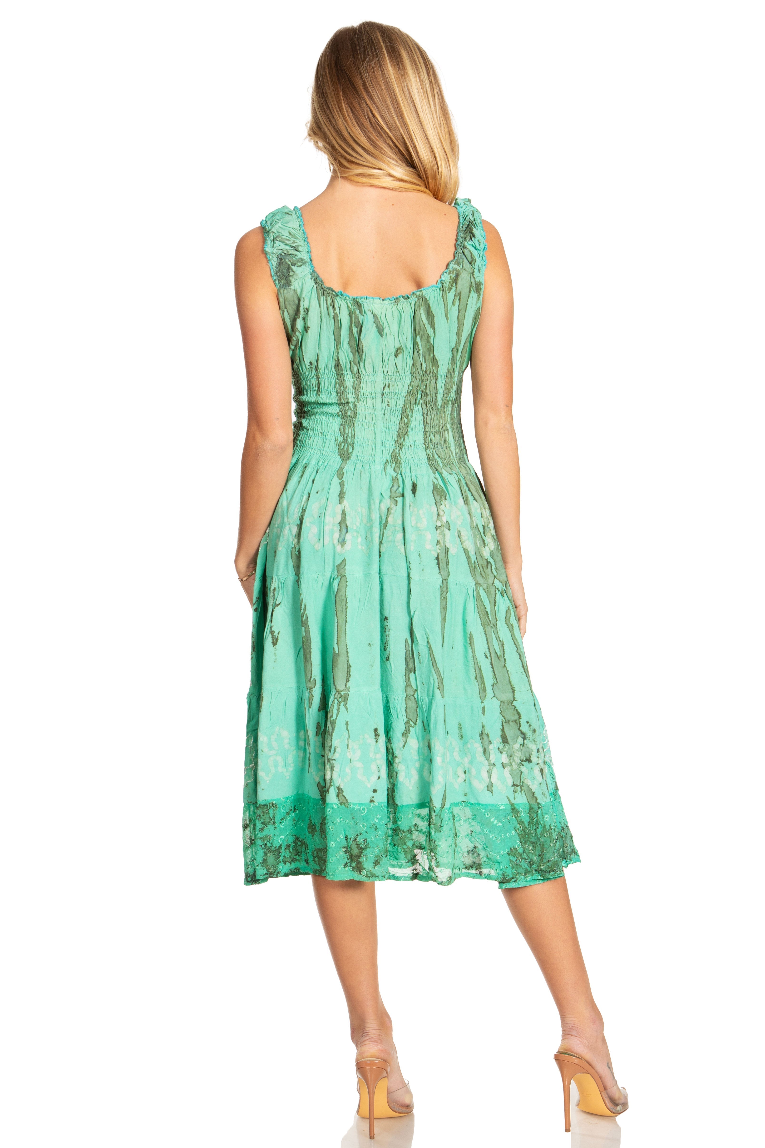 Woman wearing a green dress with a subtle pattern on a white background