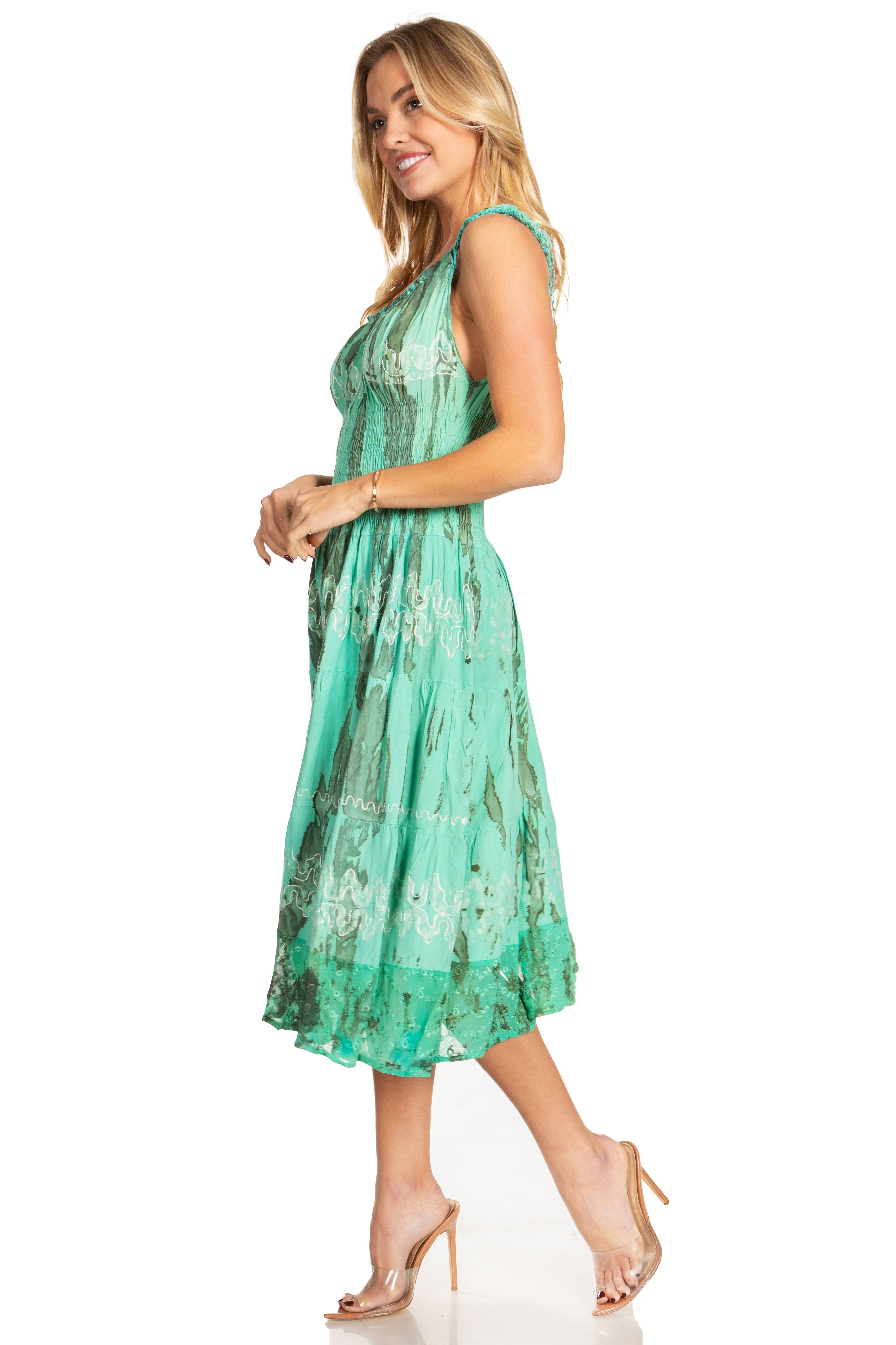 Woman wearing a green floral dress on a white background