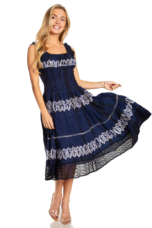 Woman wearing a navy blue dress with white lace details on a white background