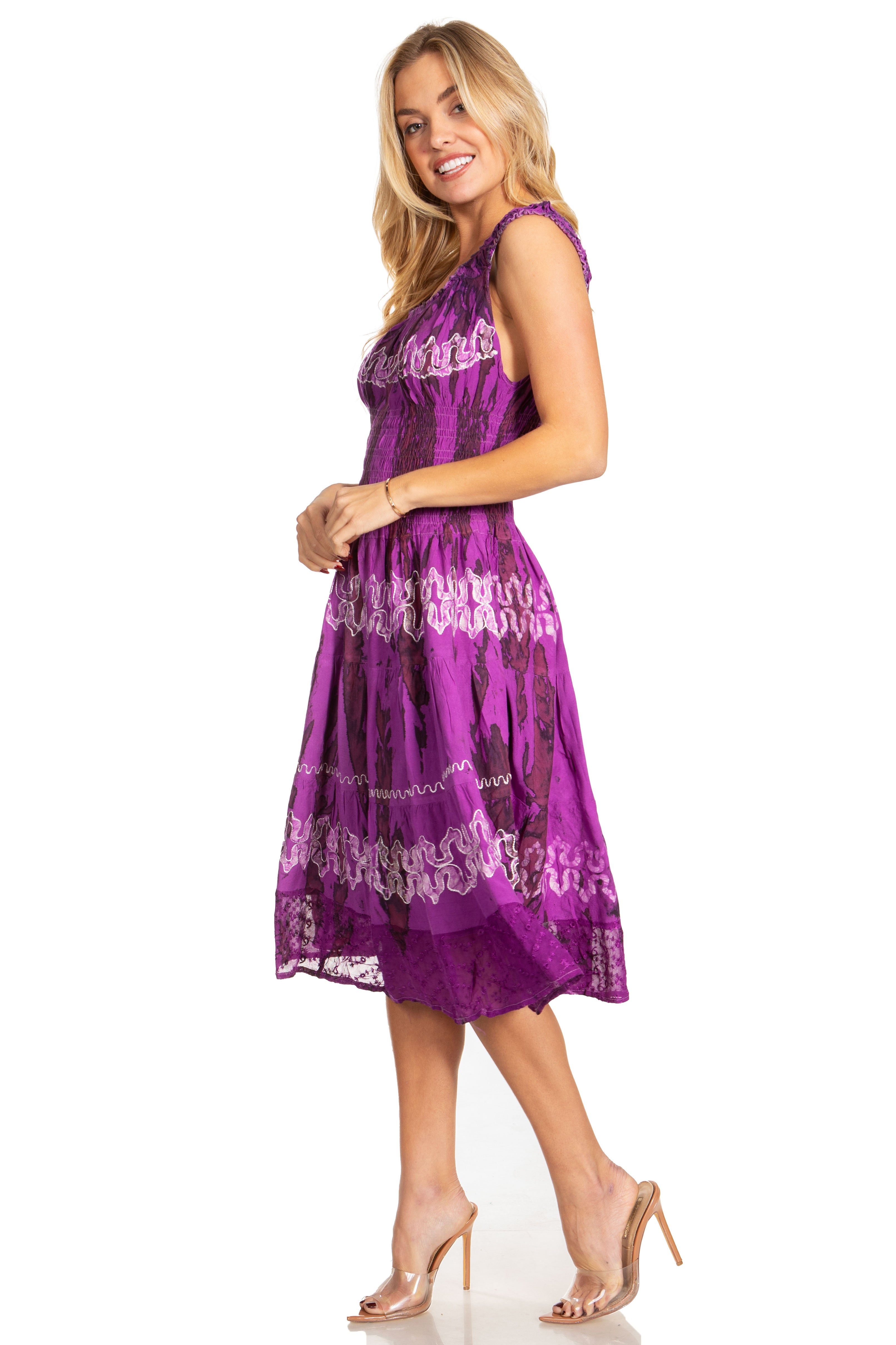 Woman wearing a purple dress with lace details on a white background