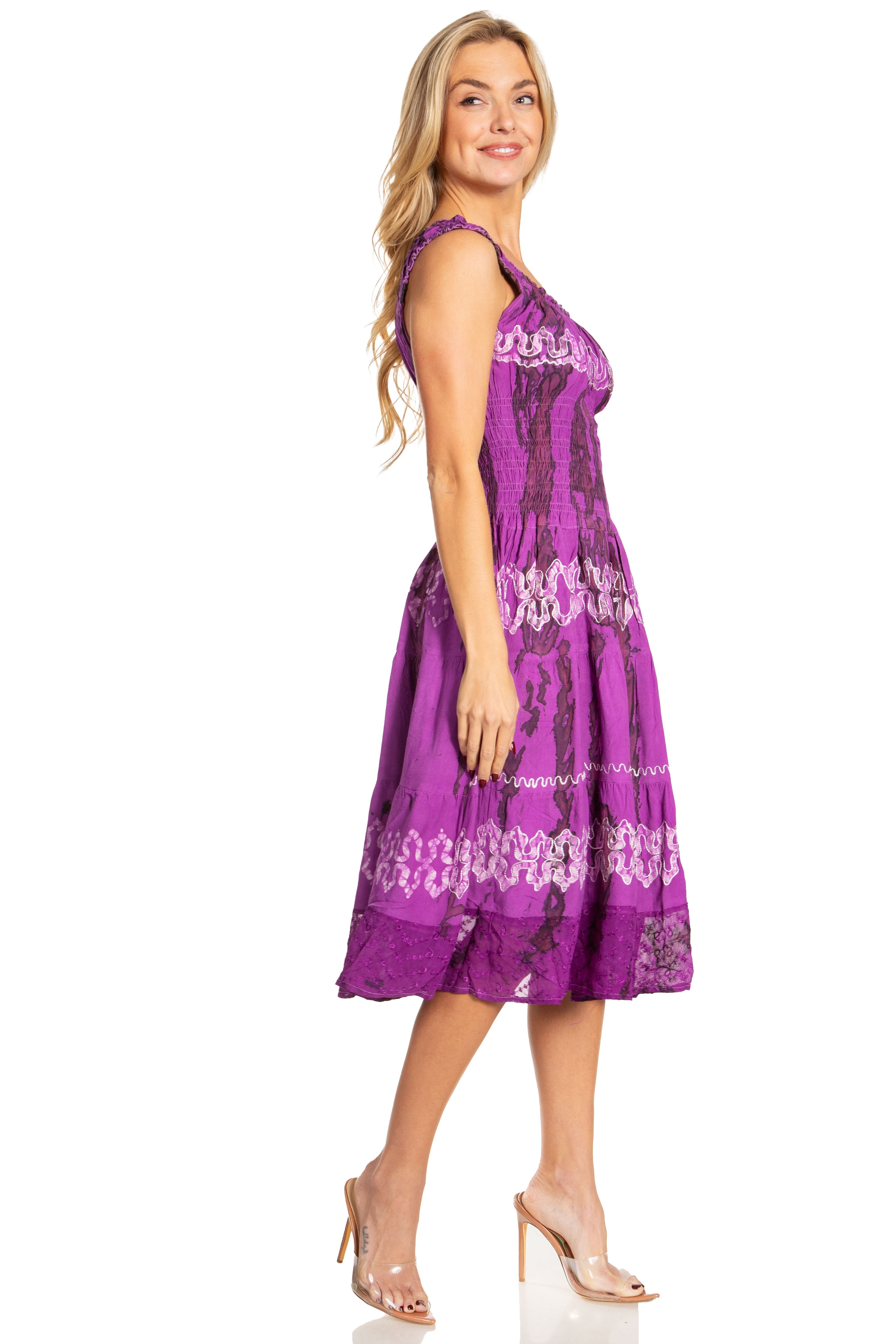 Woman wearing a purple dress with white lace details on a white background
