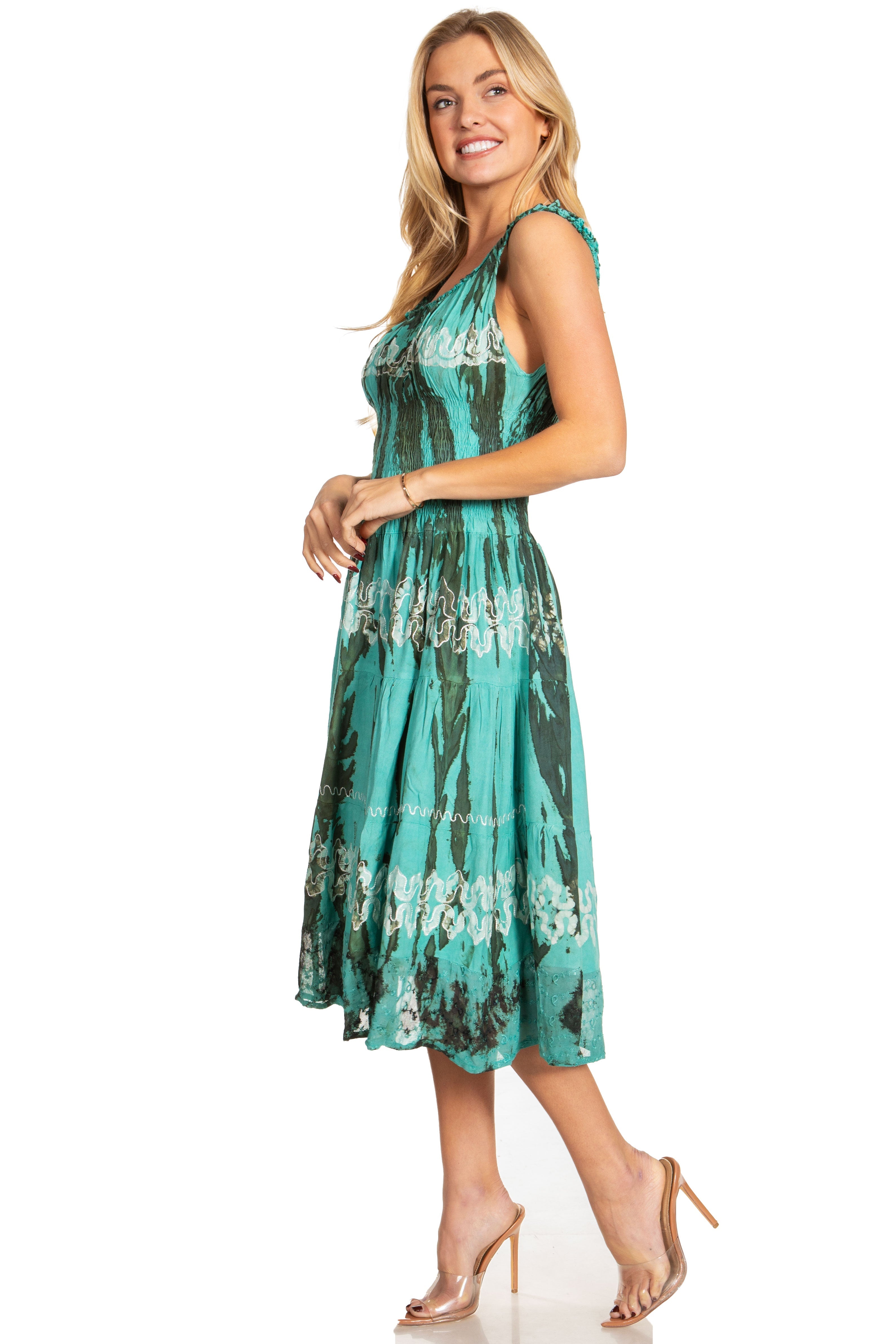 Woman wearing a green tie-dye dress on a white background