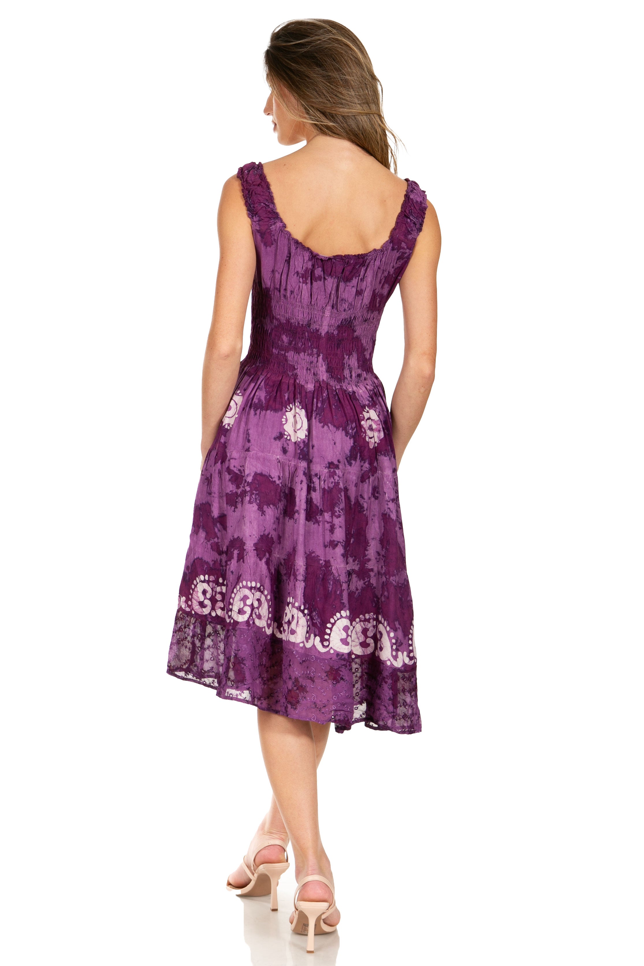 Woman wearing a purple dress with floral patterns on a white background