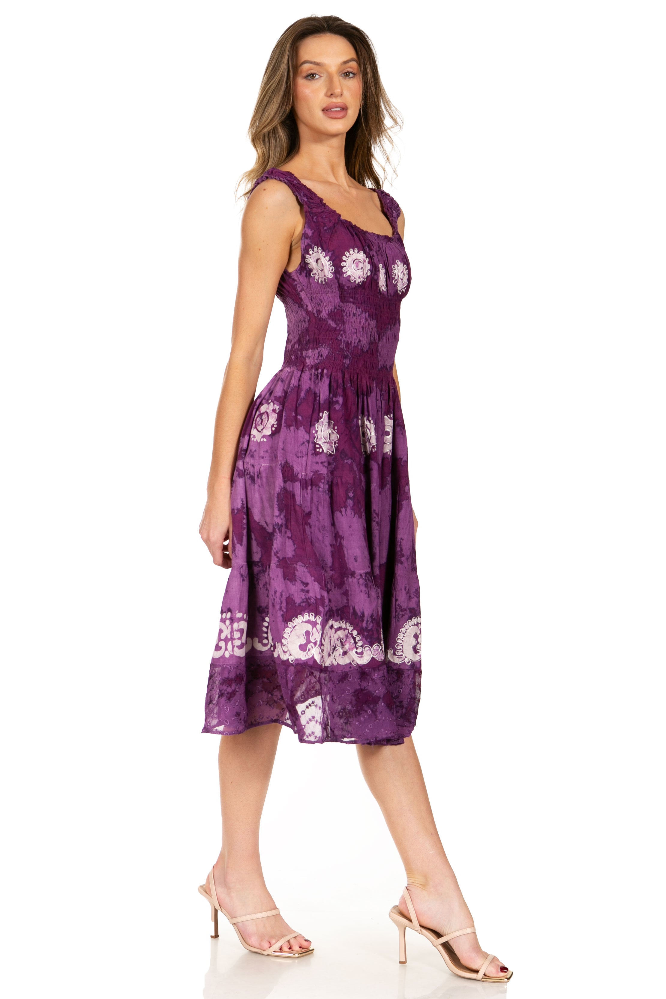 Woman wearing a purple floral dress on a white background